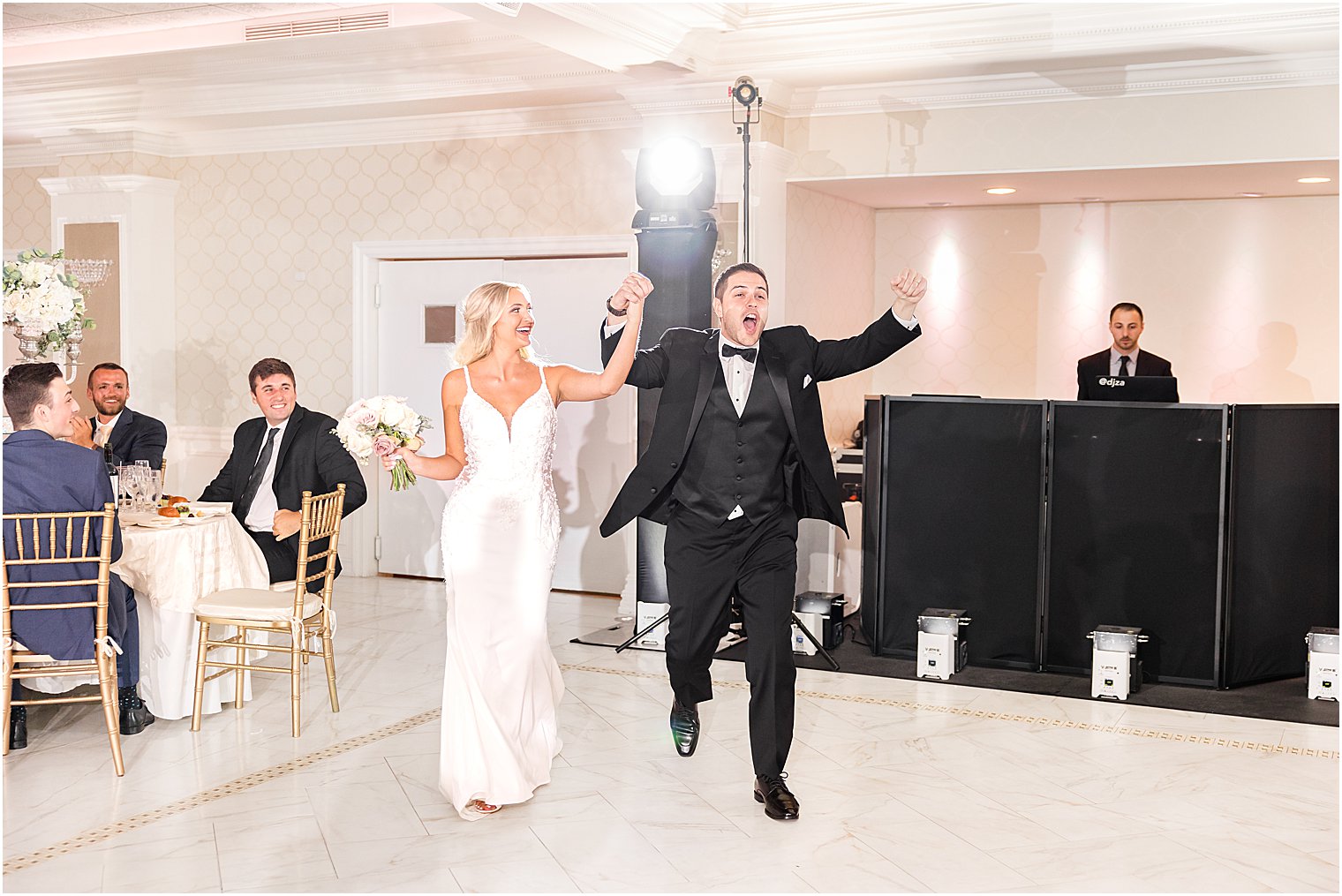 bride and groom cheer walking into wedding reception in New Jersey