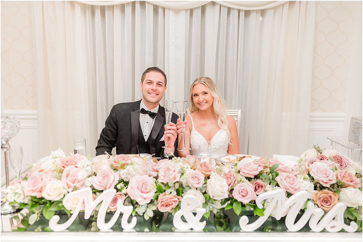 newlyweds toast champagne during wedding reception