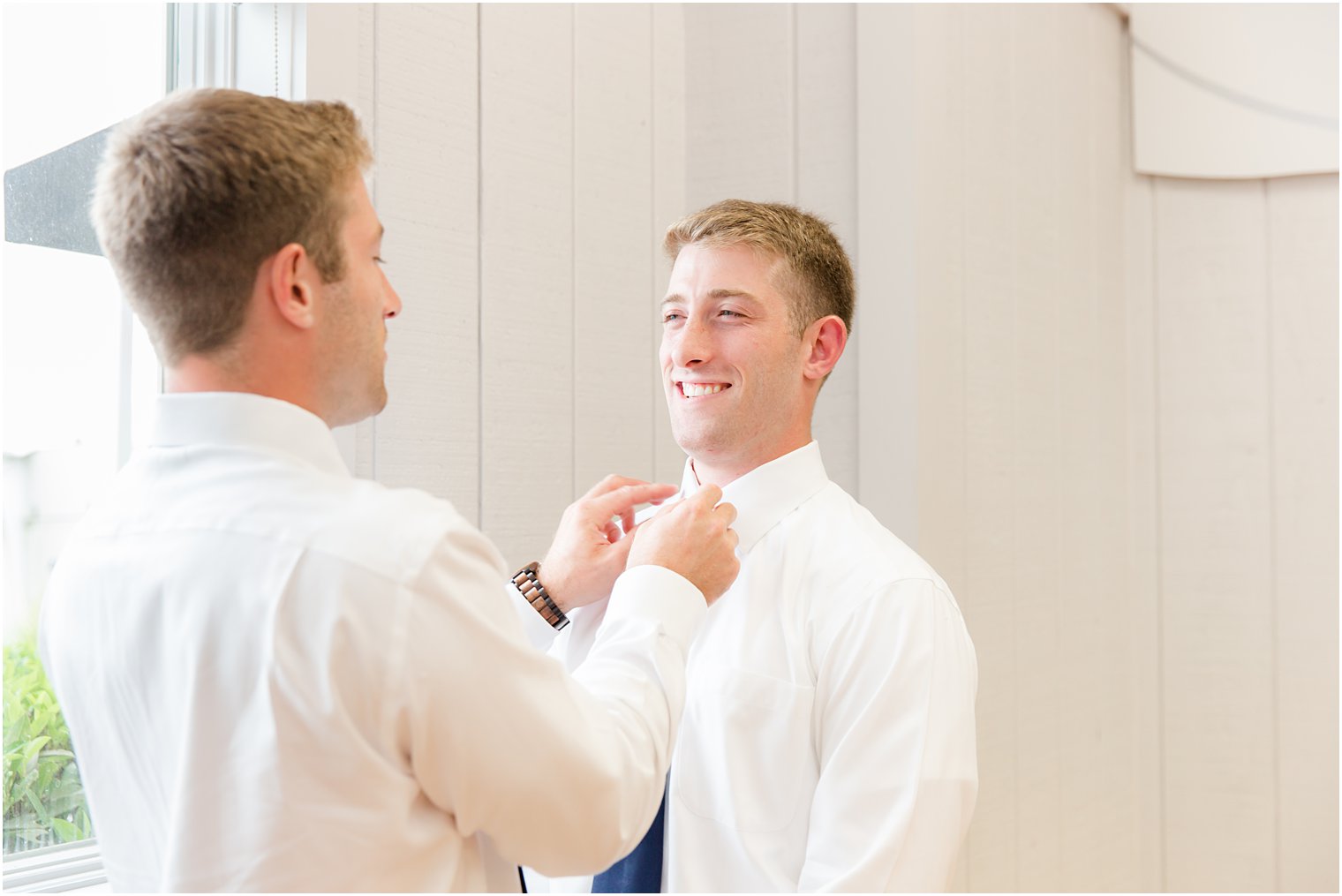 twin brother helps groom with tie before NJ wedding 