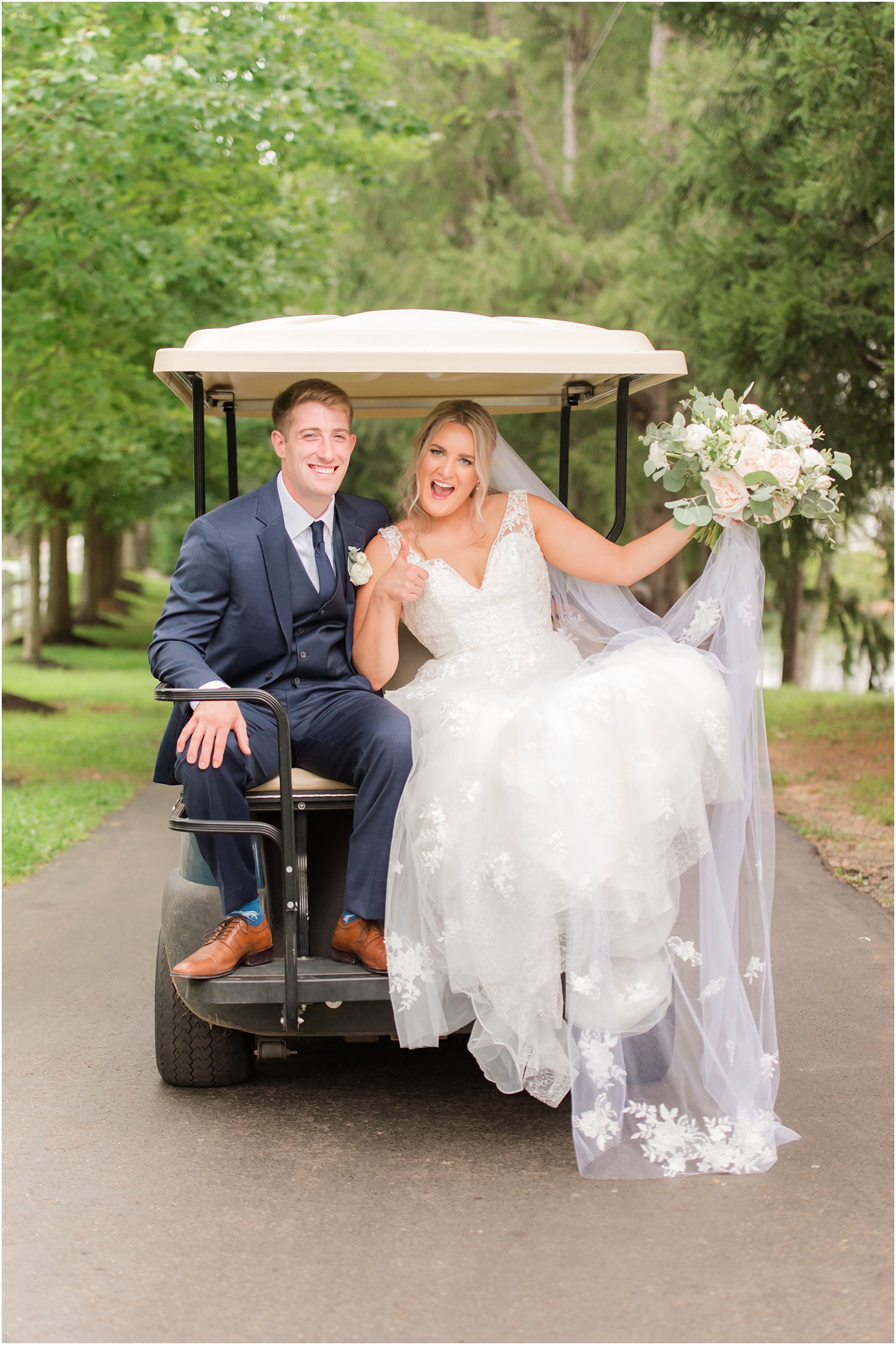 newlyweds ride in golf cart up driveway 