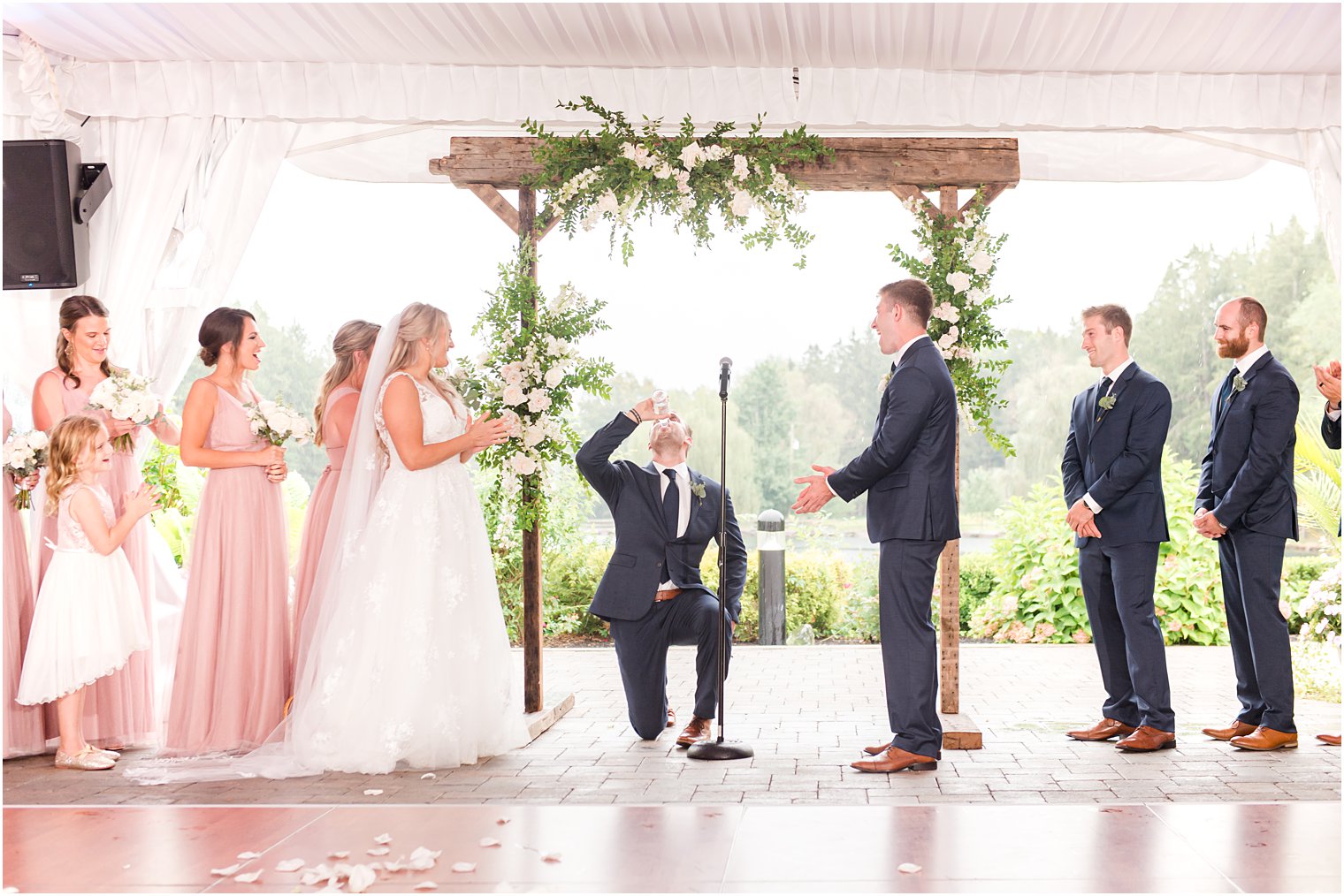 officiant drinks on one knee before ceremony 