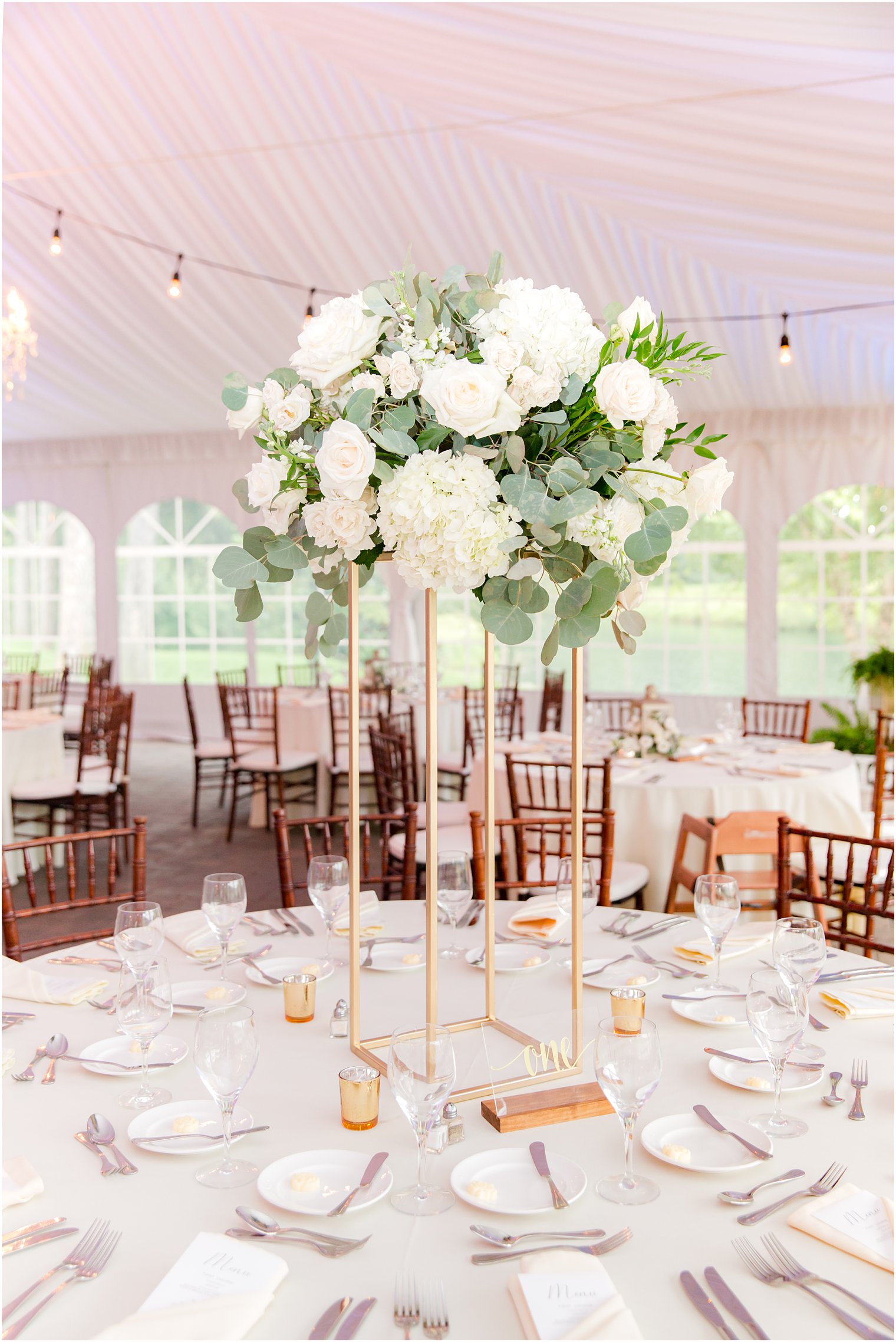 floral centerpieces with white flowers under tent at Windows on the Water at Frogbridge