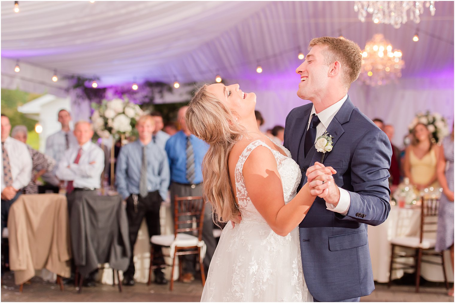 bride laughs tossing back head during dance under tent at Windows on the Water at Frogbridge