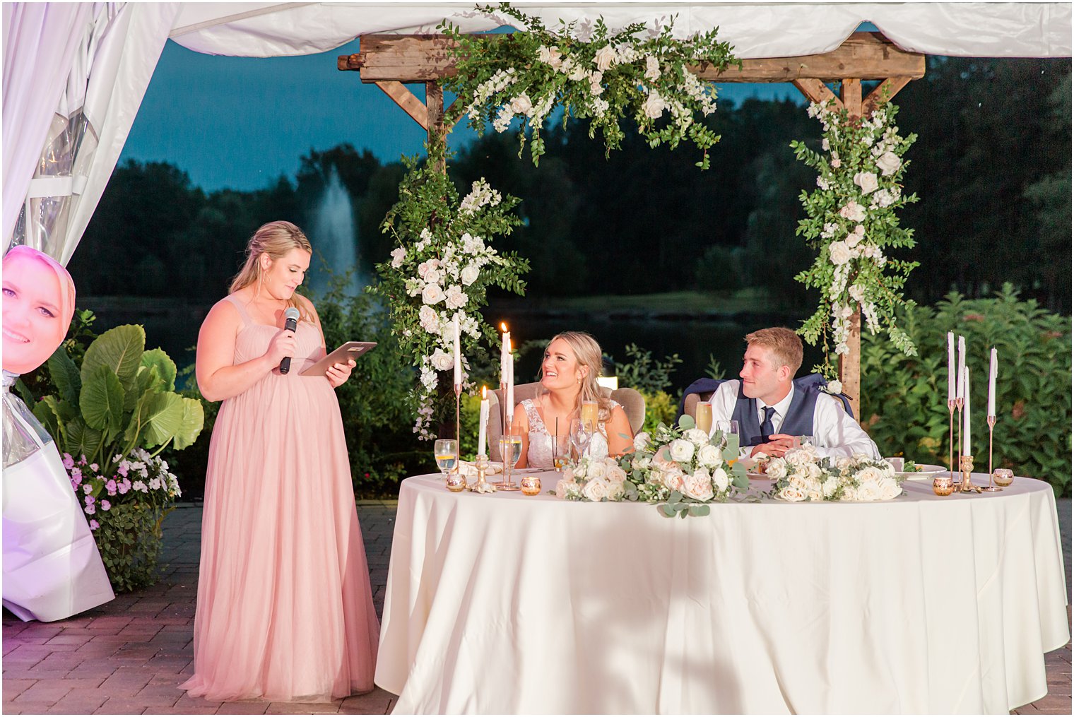 bridesmaid reads speech to bride and groom during NJ wedding reception 