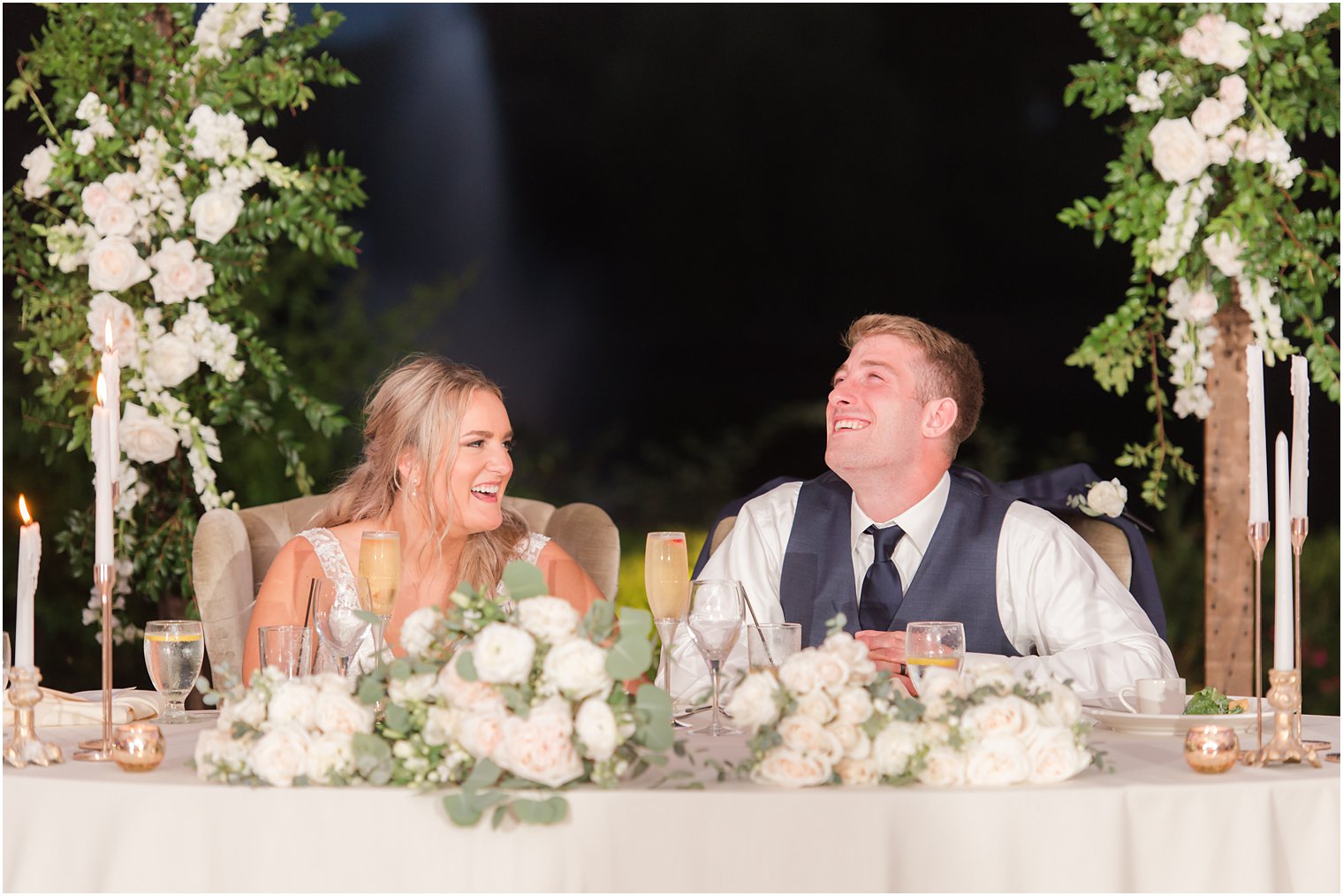 newlyweds laugh during wedding toasts 