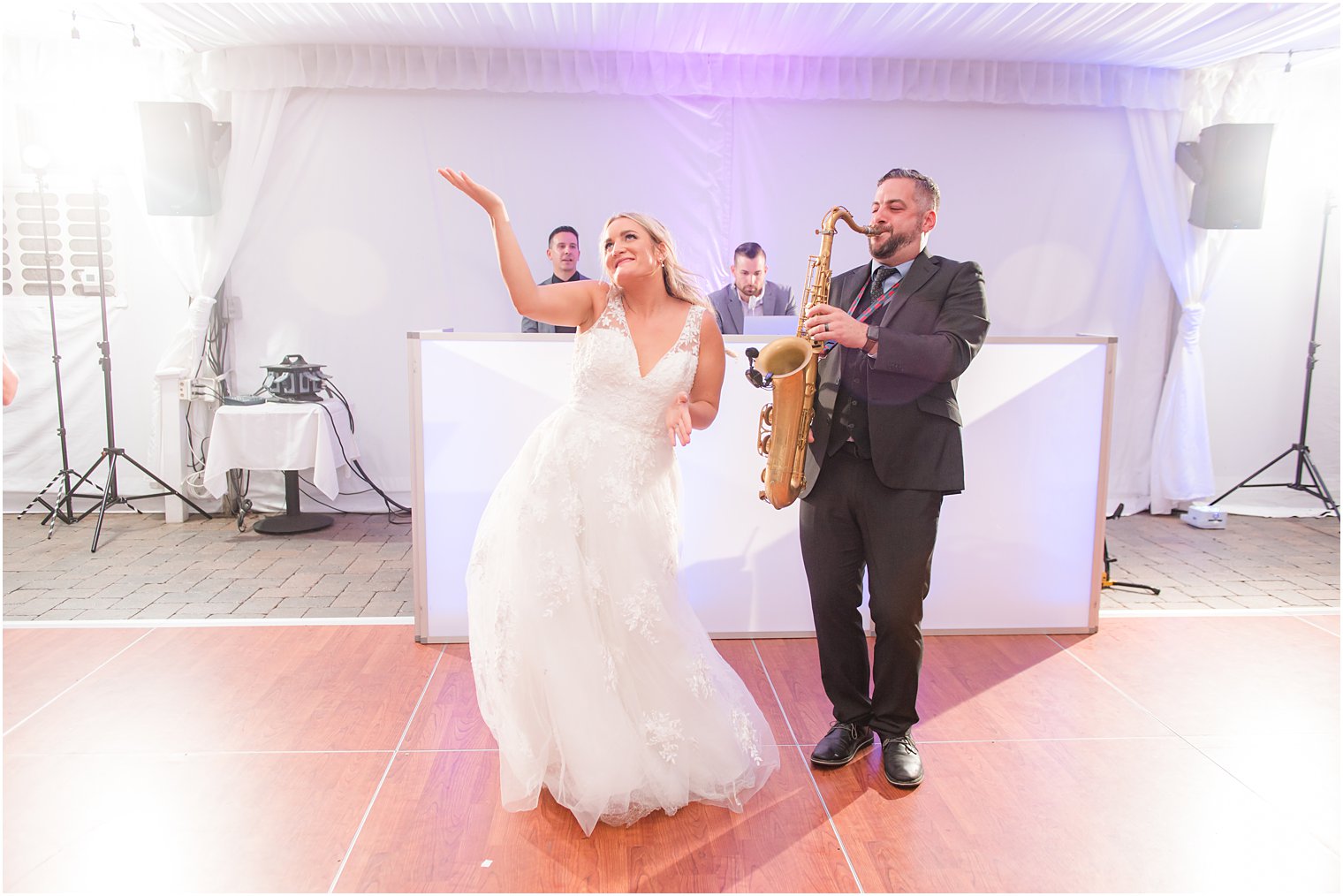 bride dances next to saxophone player at reception 