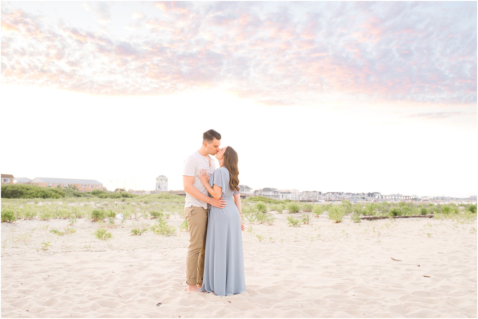 engaged couple kisses under sunset on Jersey Shore