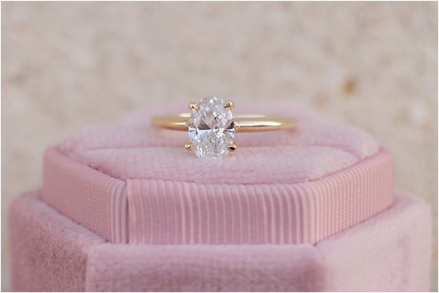 diamond ring rest on pink ring box 