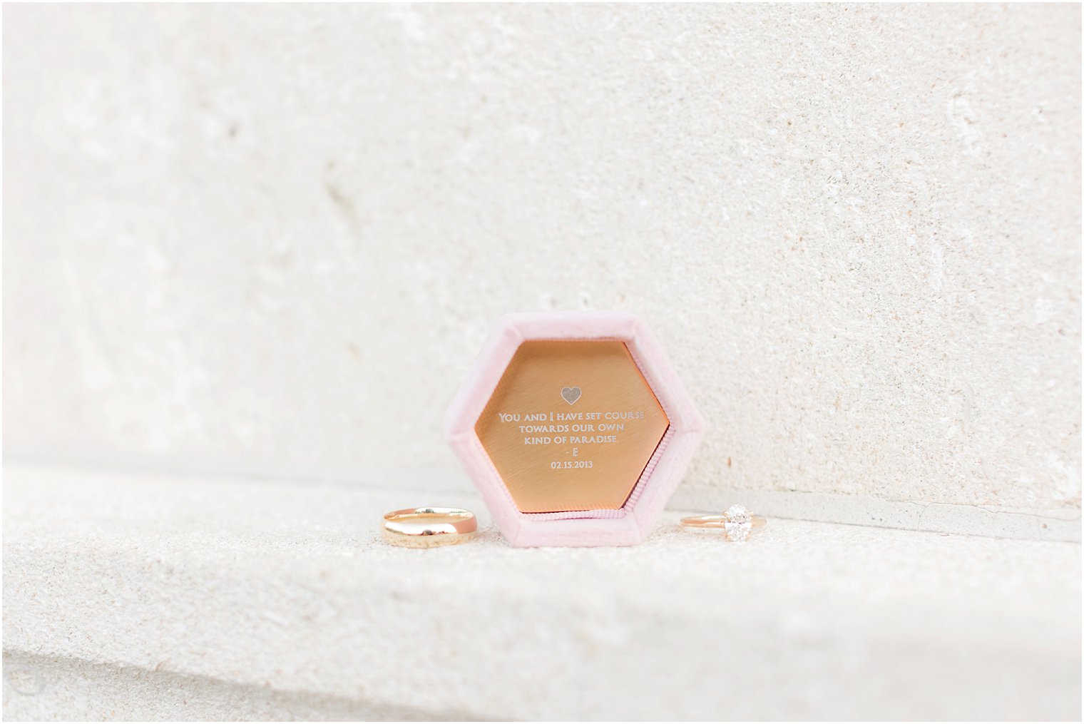 engagement ring lays next to custom box with inscription 