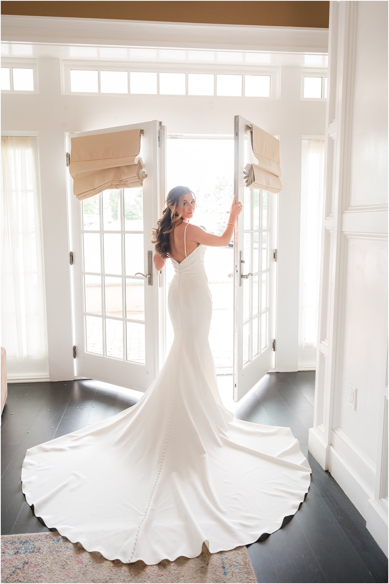 bride stands in windows at Ryland Inn