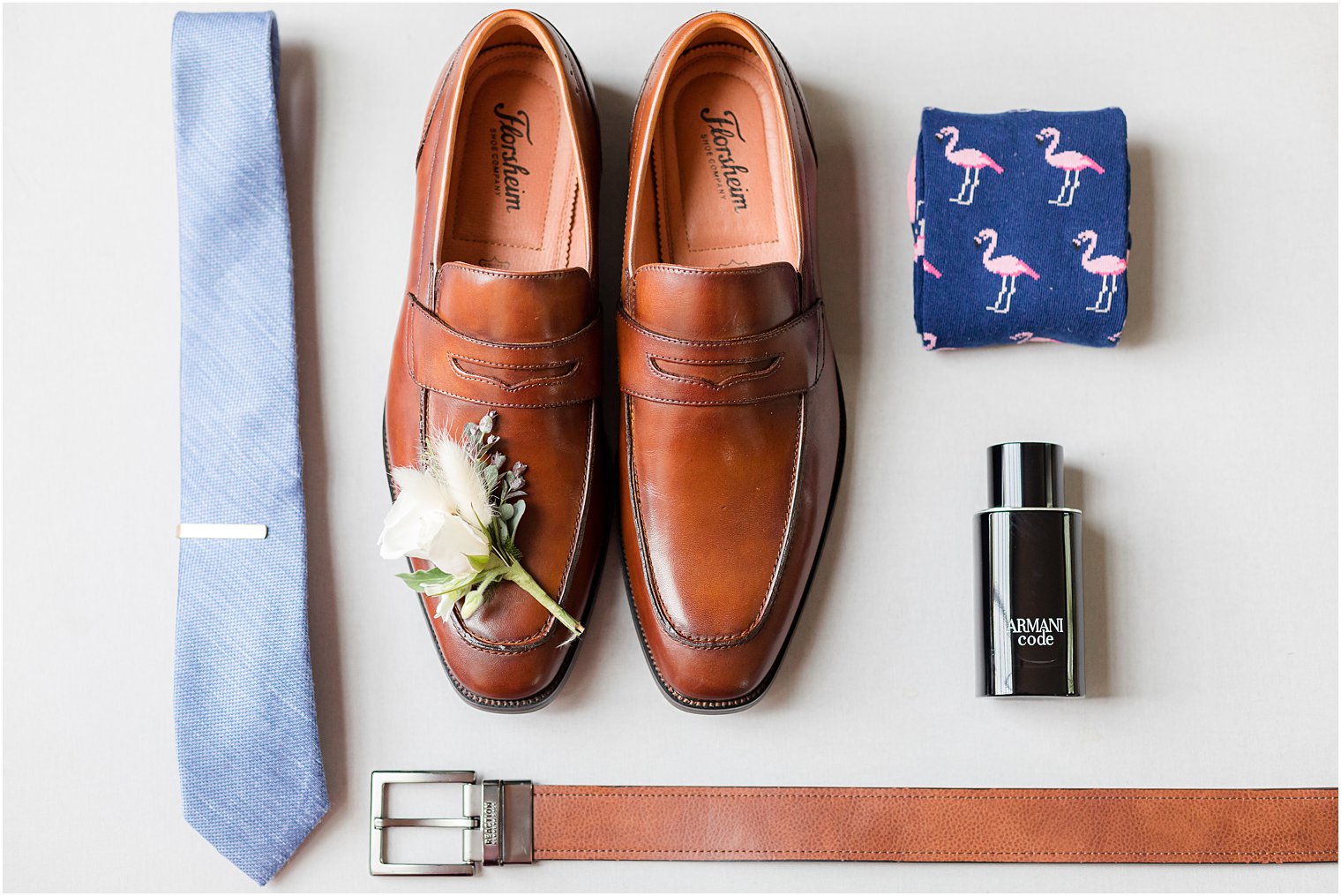 groom's brown shoes and navy tie