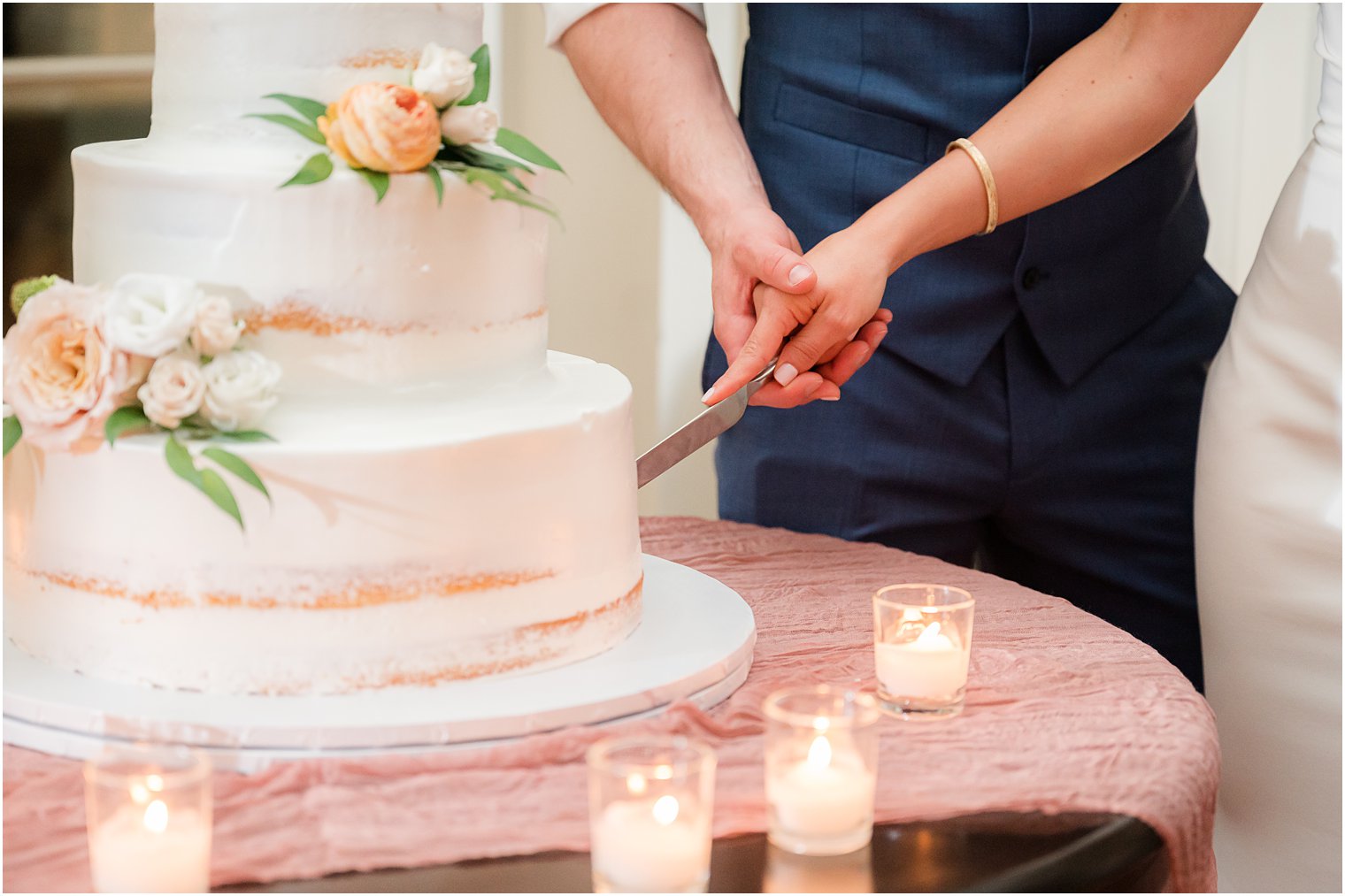 couple cuts cake together during Ryland Inn wedding reception