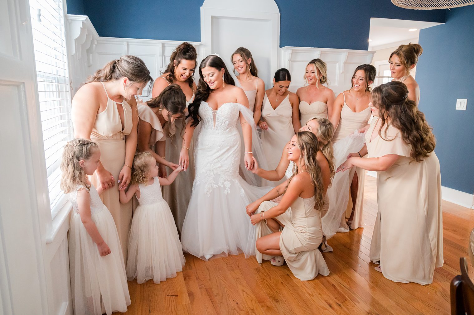 Bride surrounded by her braidsmaids in her big day at The Mill Lakeside Manor