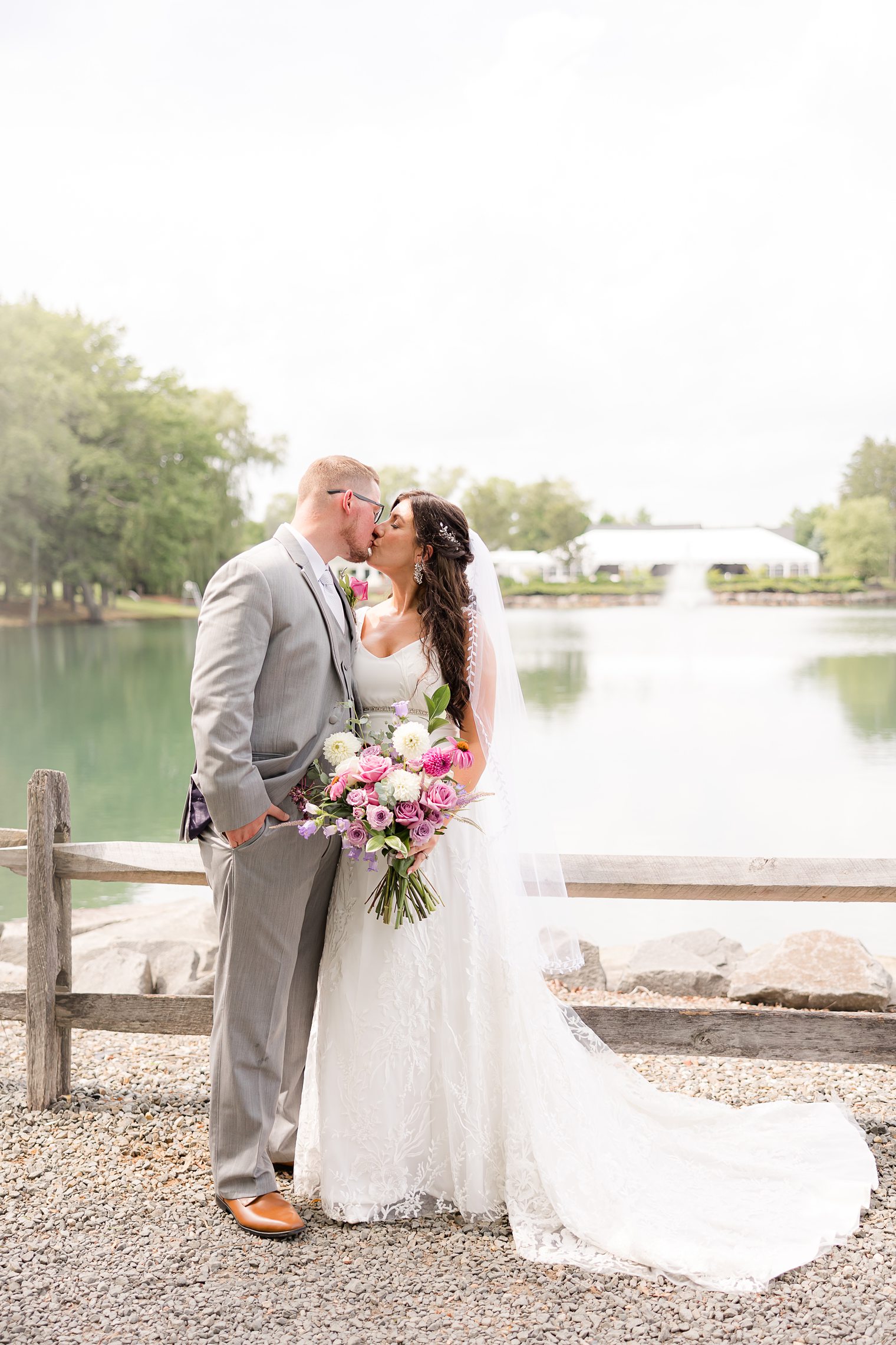 Couple kissing after their first look at the venue they choose to say I Do Windows on the Water at Frogbridge Wedding