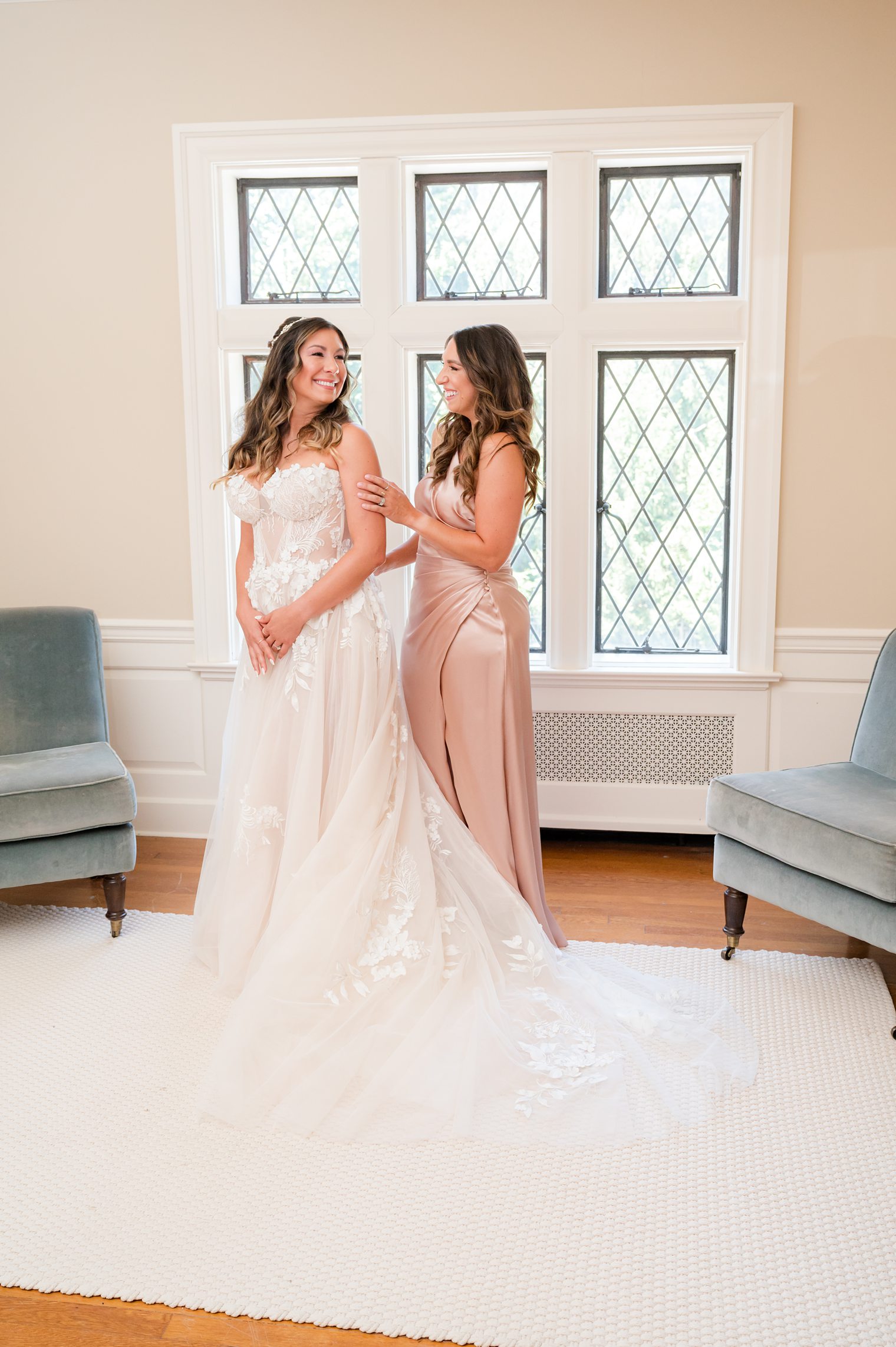 Beautiful bride smiling and enjoying her moment with her bridesmaid Riverhouse at Rumson Country Club