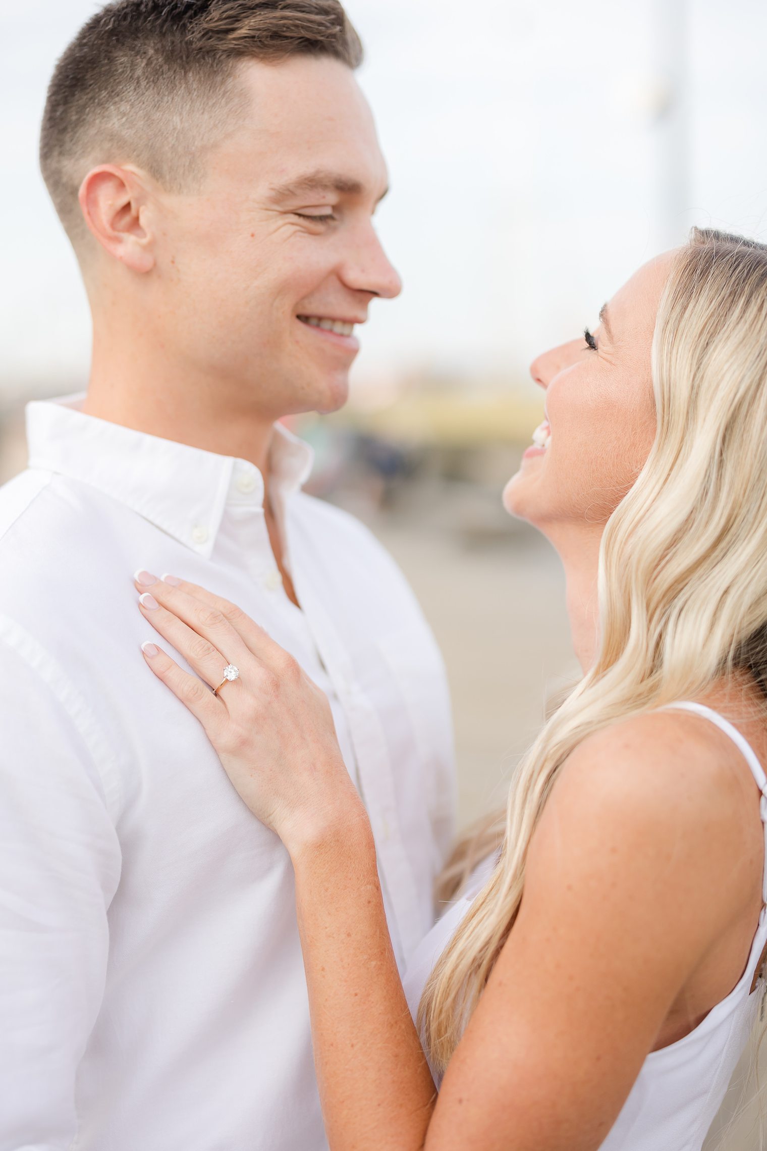 happy couple enjoying their engagement session at Seaside Heights Boardwalk 