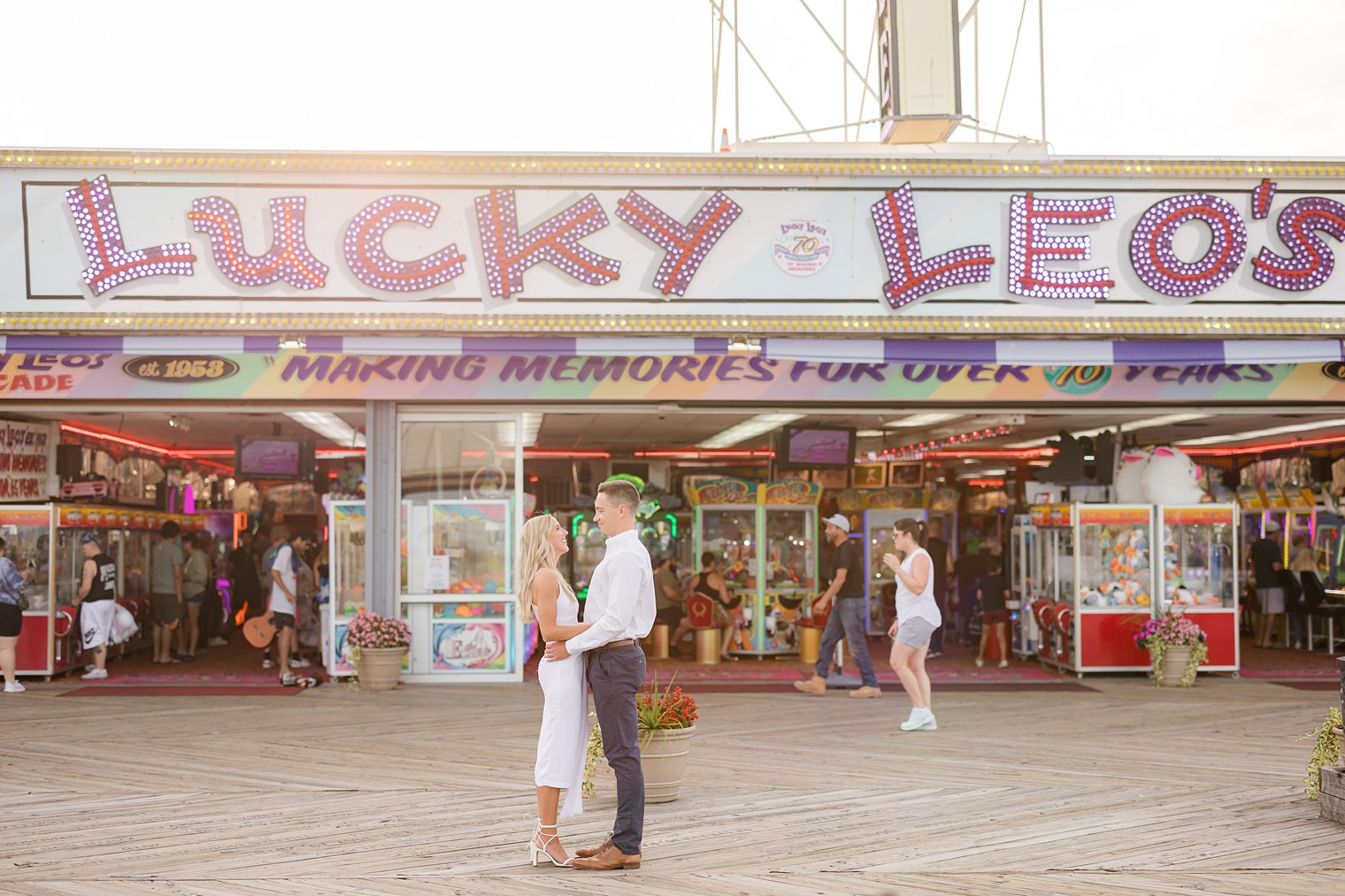 couple standing in front of Lucy Leos at Seaside Heights Boardwalk 
