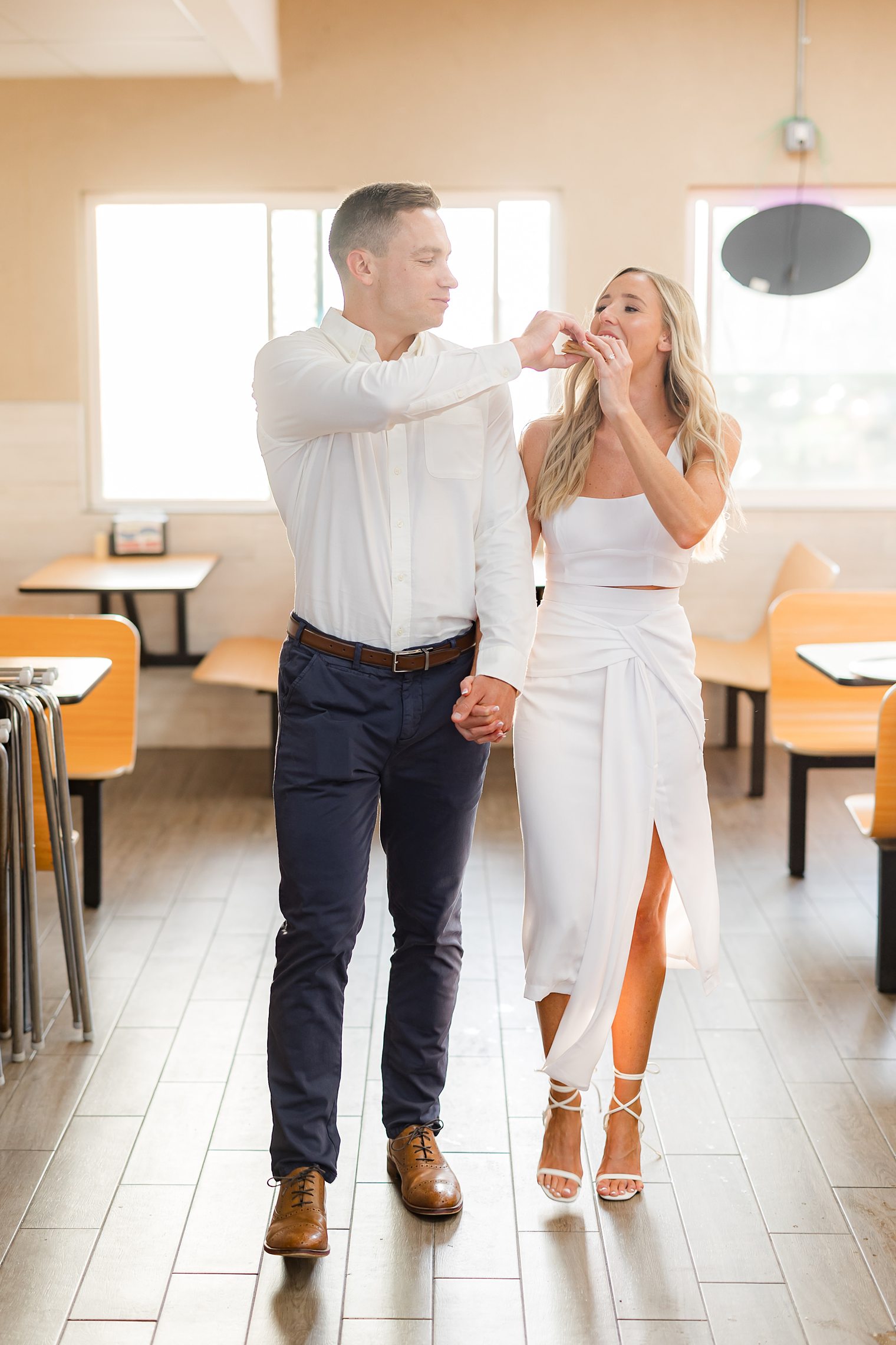 bride and groom being unique, enjoying pizza 