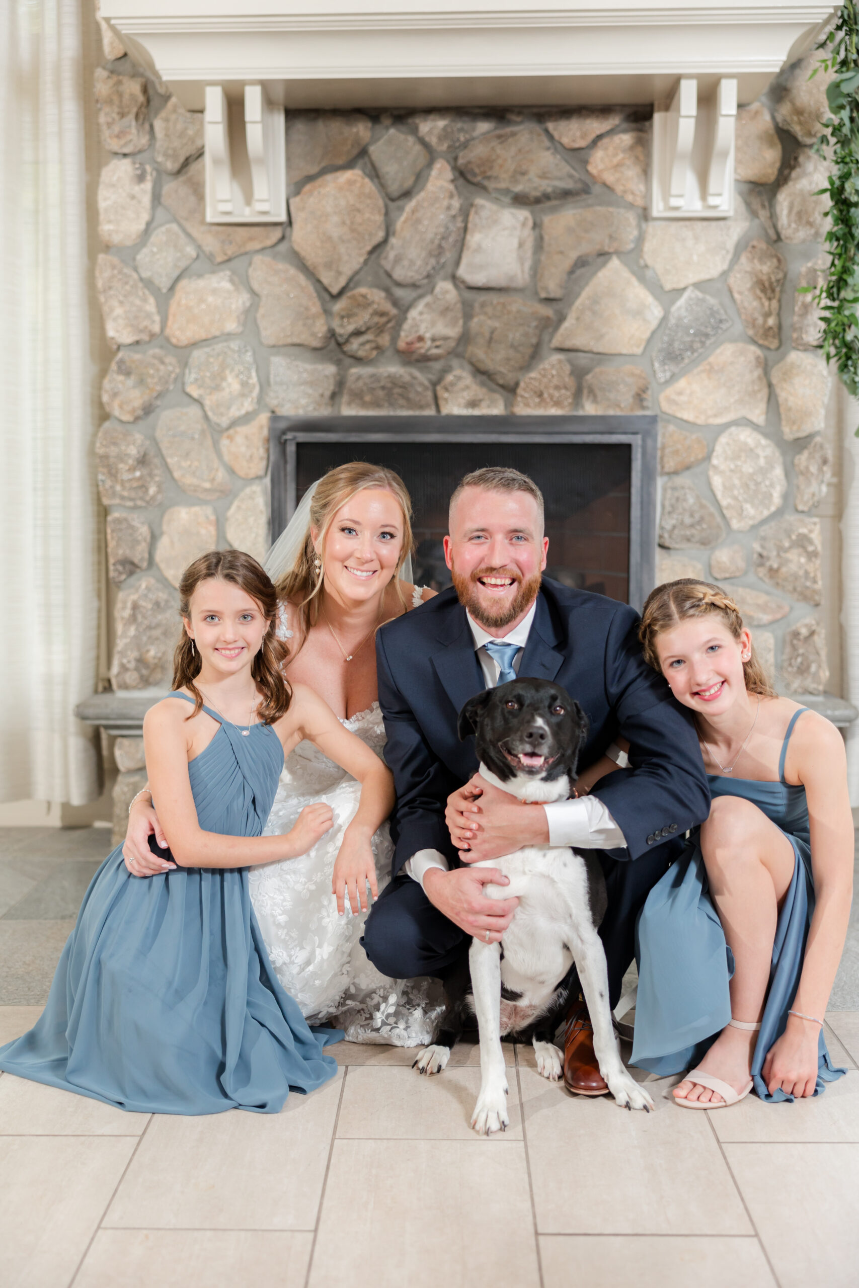 bride and groom with their daughters' and furry friend 