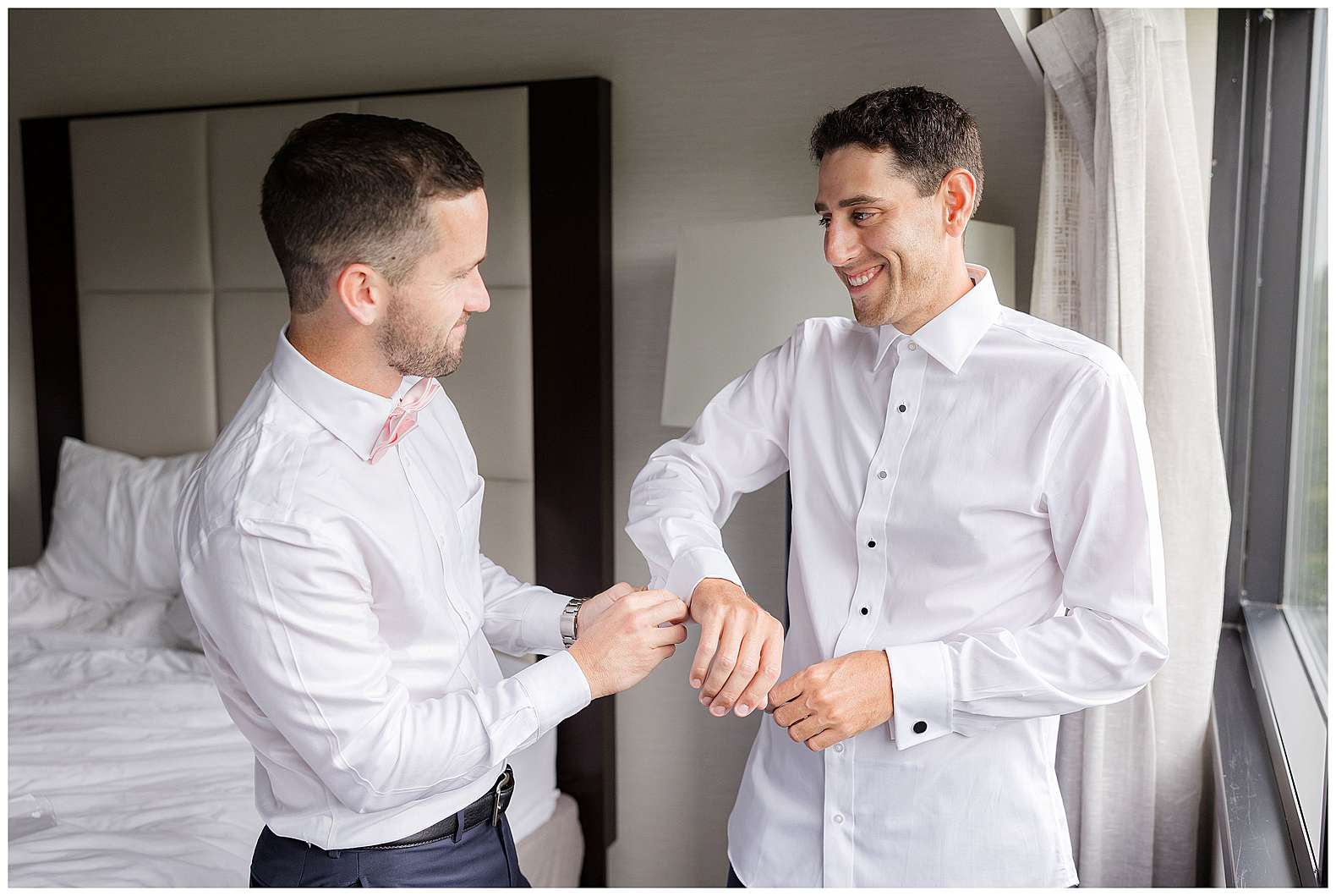 best man helping groom put on cufflinks