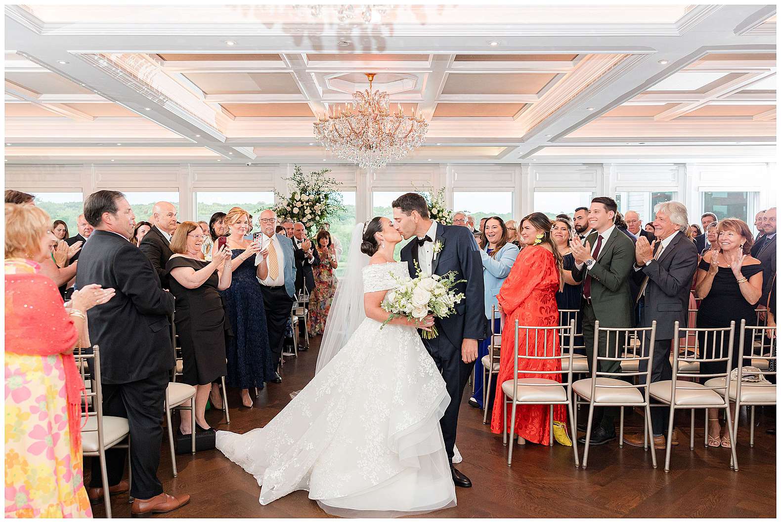 bride and groom kissing as they walk down the aisle at The Mill Lakeside Manor in Spring Lake, NJ