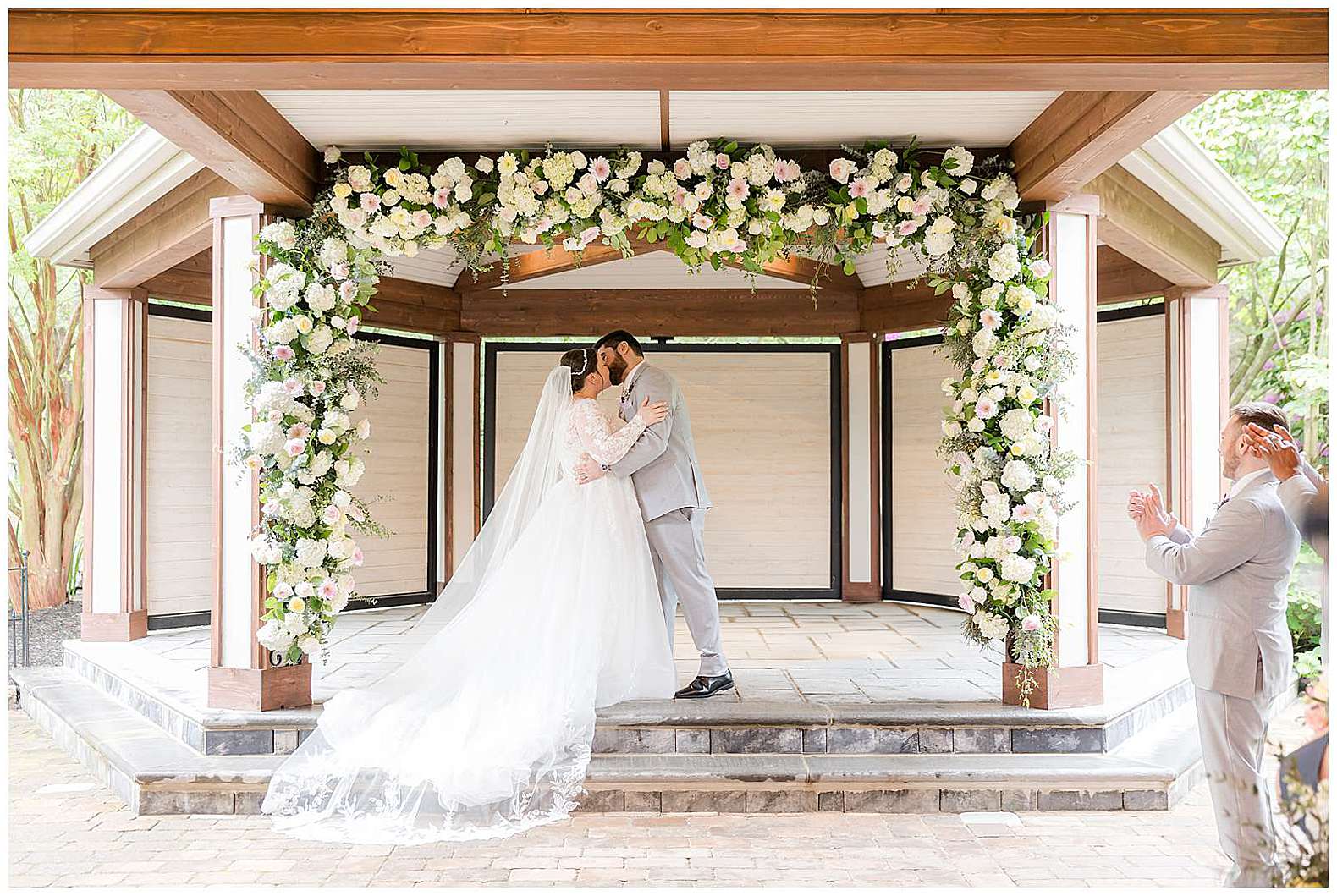 bride and groom first kiss during Scotland Run wedding in Williamstown, NJ