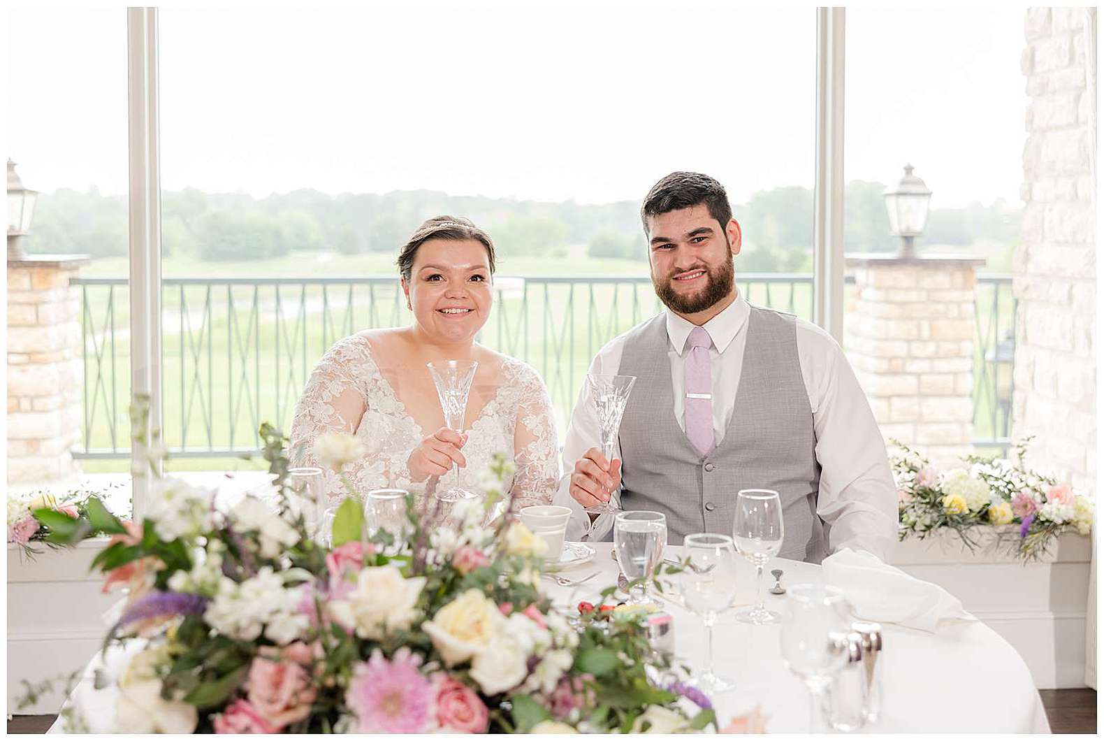 bride and groom at sweetheart table at Scotland Run wedding in Williamstown, NJ