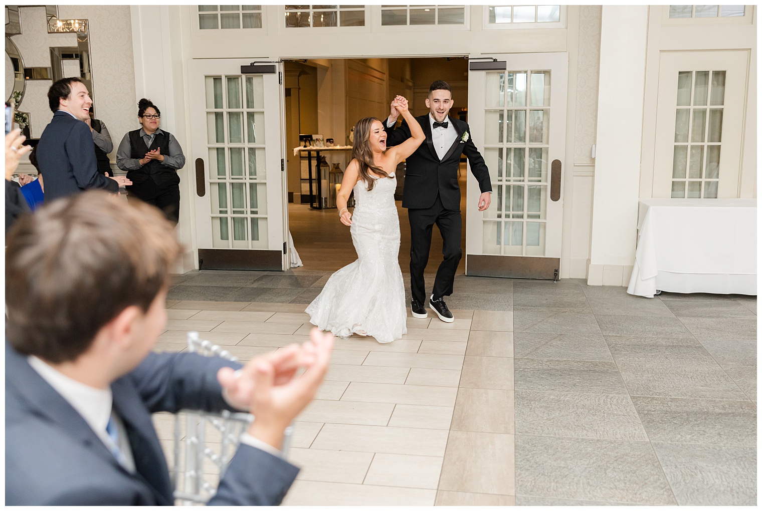 bride and groom entering to the ballroom