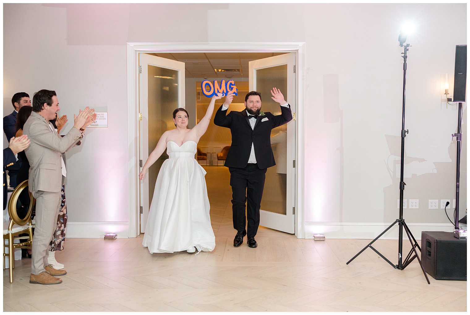 bride and groom entering the ballroom