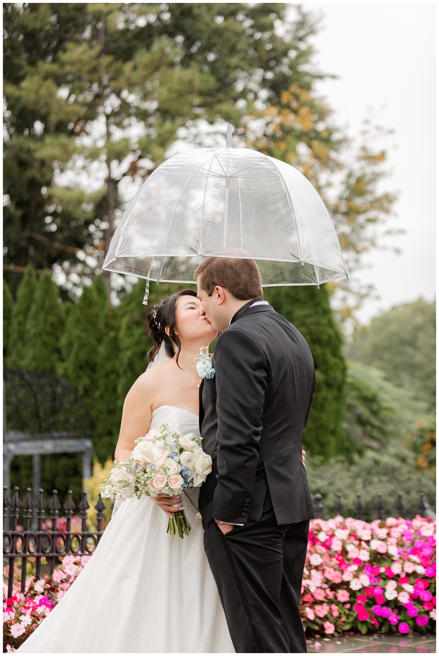 bride and groom kissing under the rain