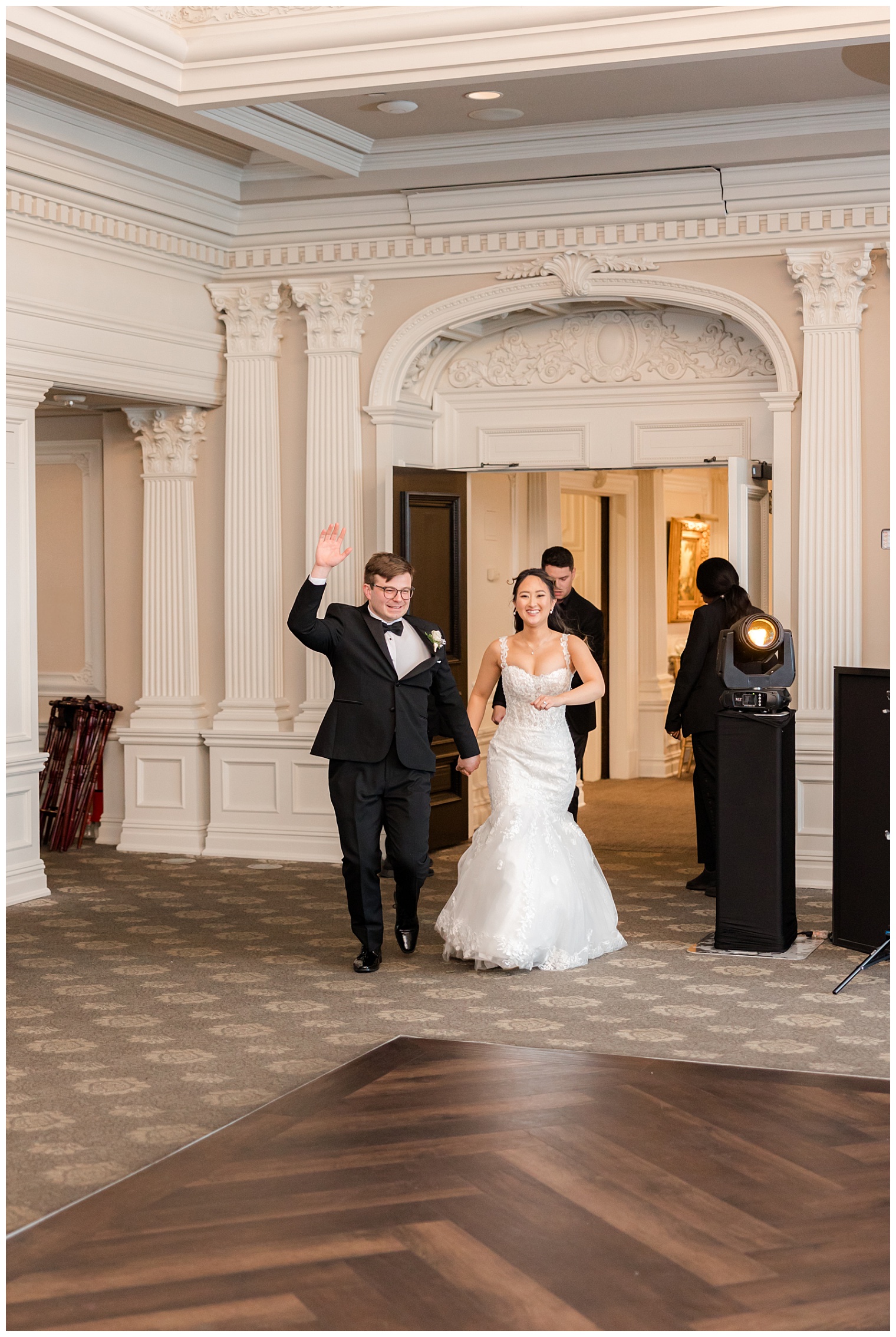 bride and groom entering the ballroom
