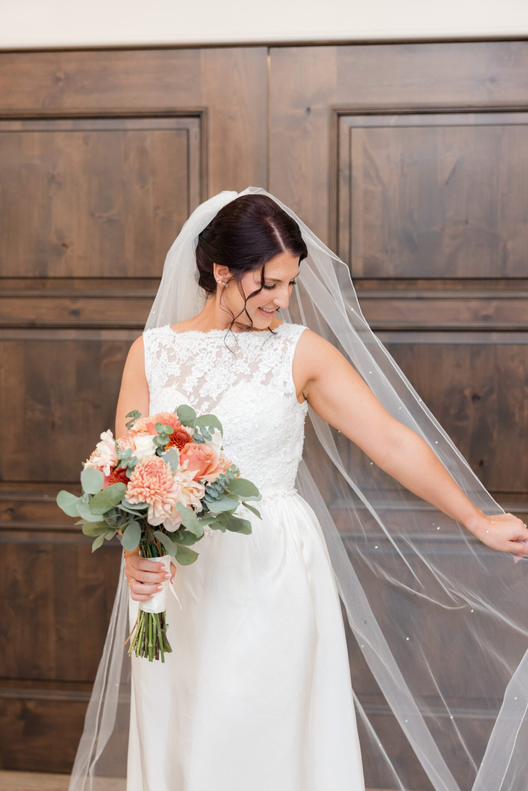 Bride twirls softly, her veil floating as she glows with happiness