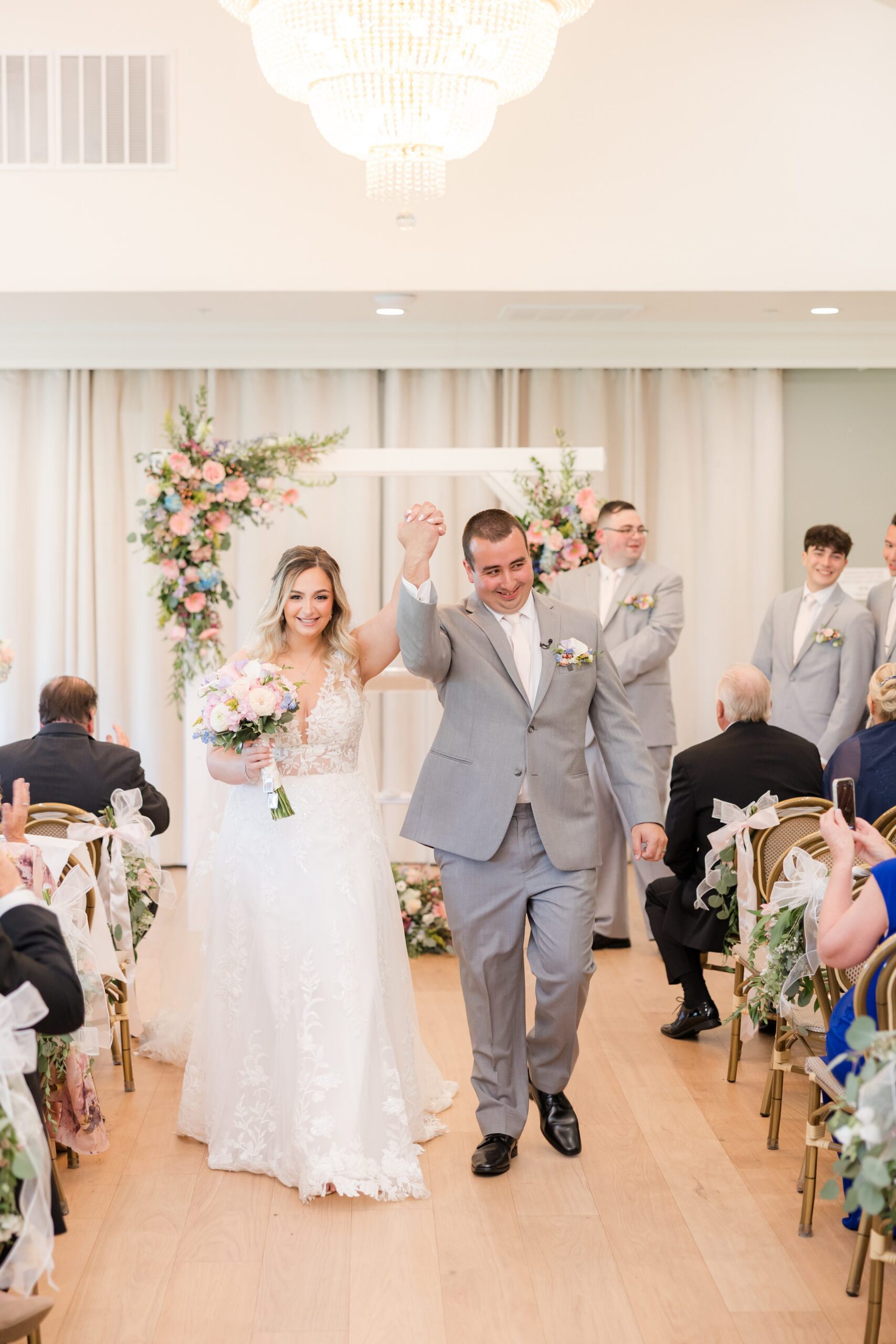 Bride and groom walking back up the aisle together after the ceremony