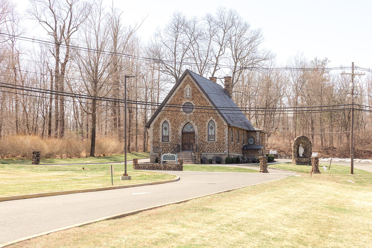 Wide exterior photo of rustic stone chapel wedding venue