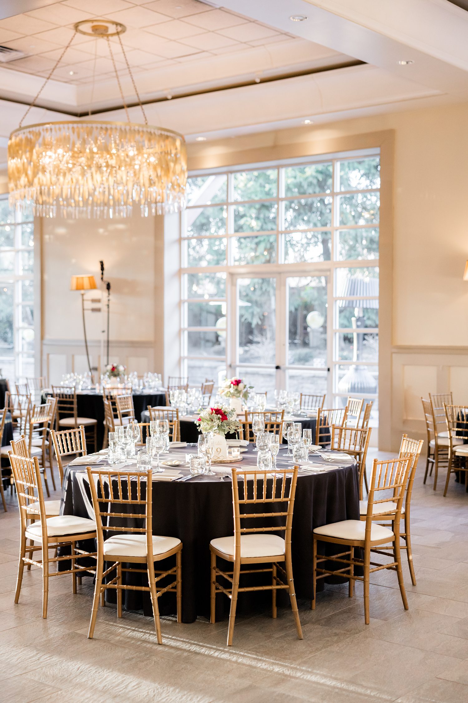 Bright reception space with luxury chandelier and elegant table decor