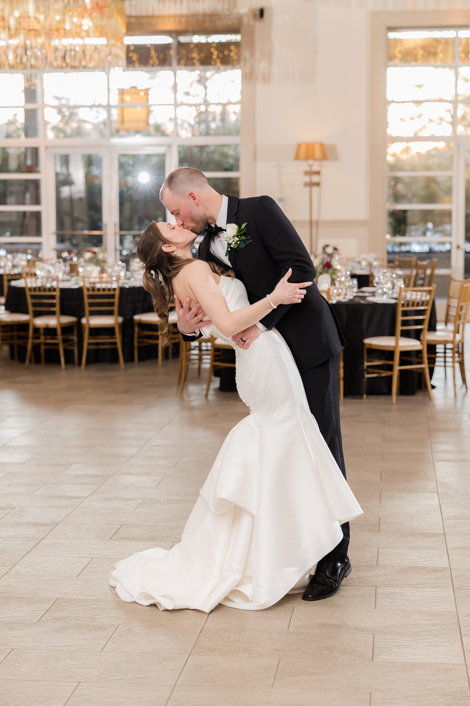 Bride and groom dancing in elegant reception ballroom