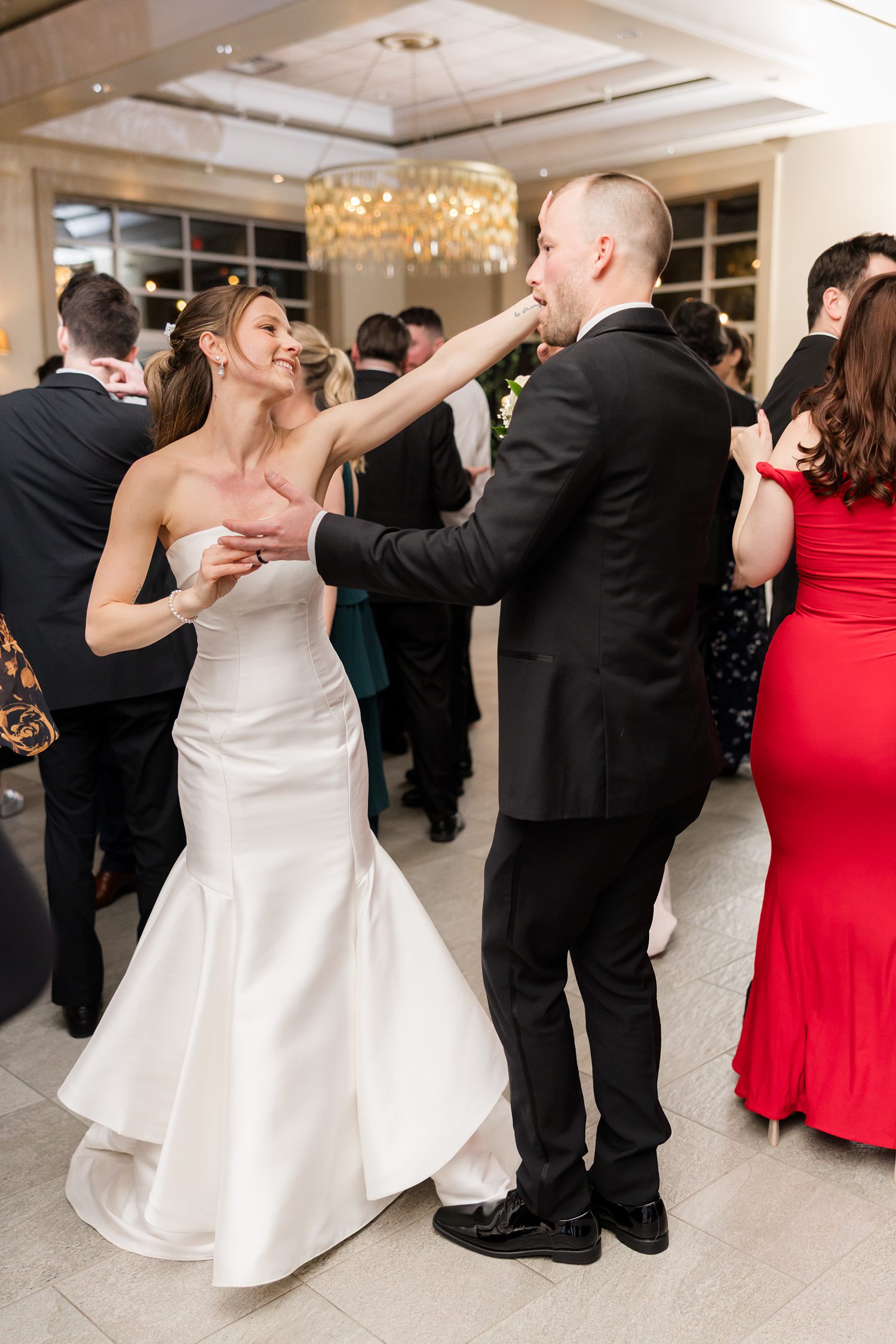 Fun wedding dance floor moment with bride and groom celebrating