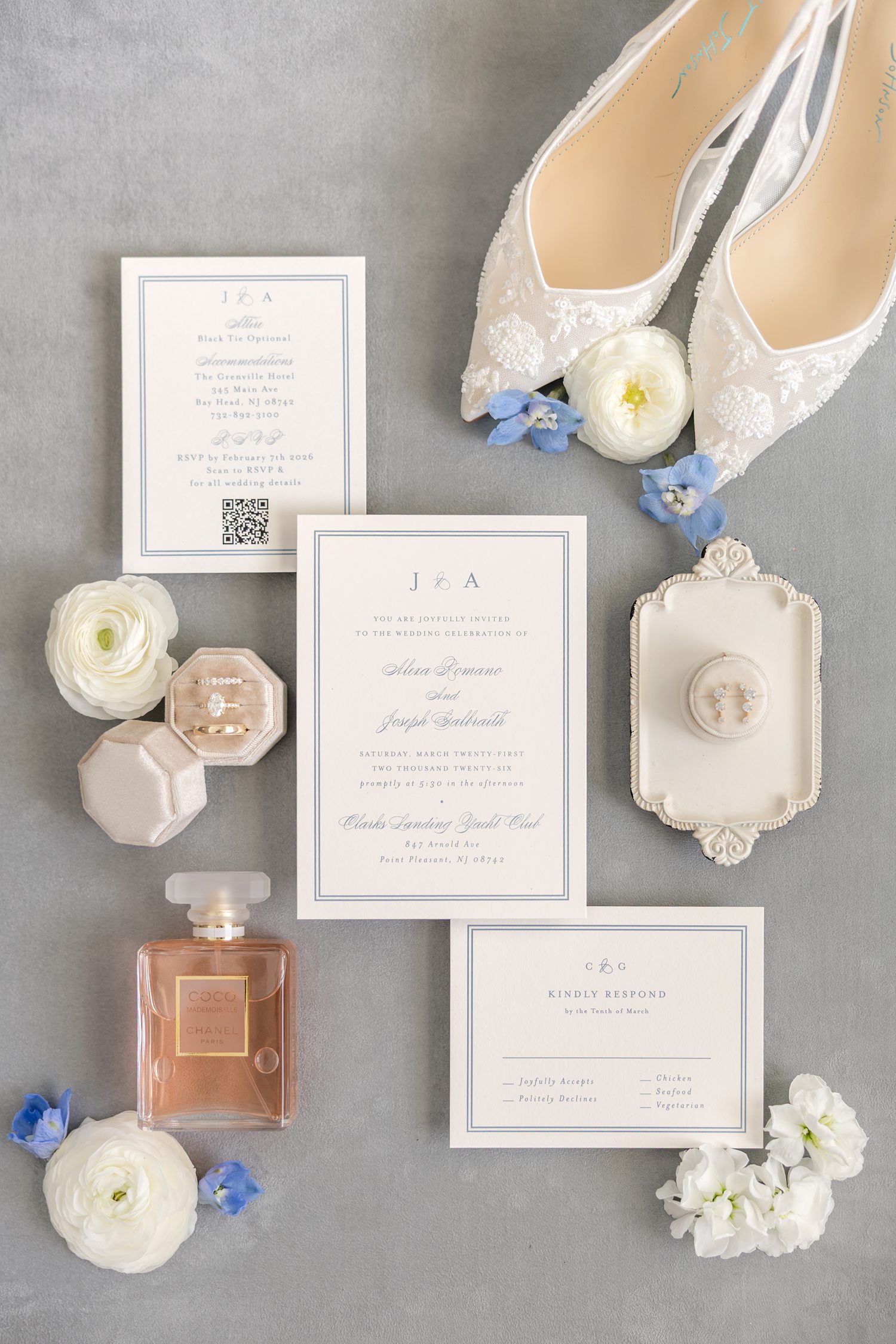 Elegant wedding invitation suite with blue and white floral flat lay styling