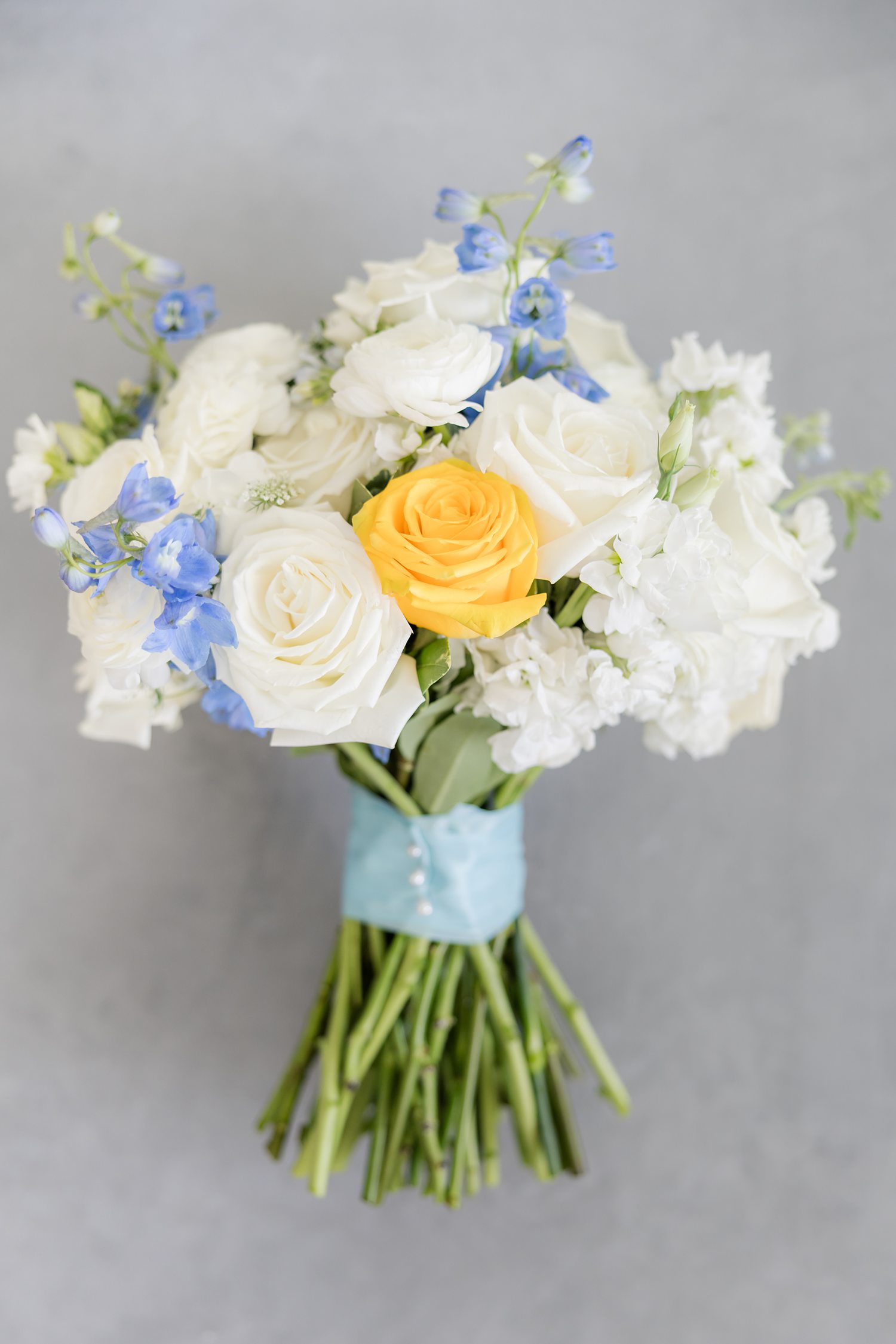 Blue and yellow bridal bouquet styled for elegant yacht club wedding
