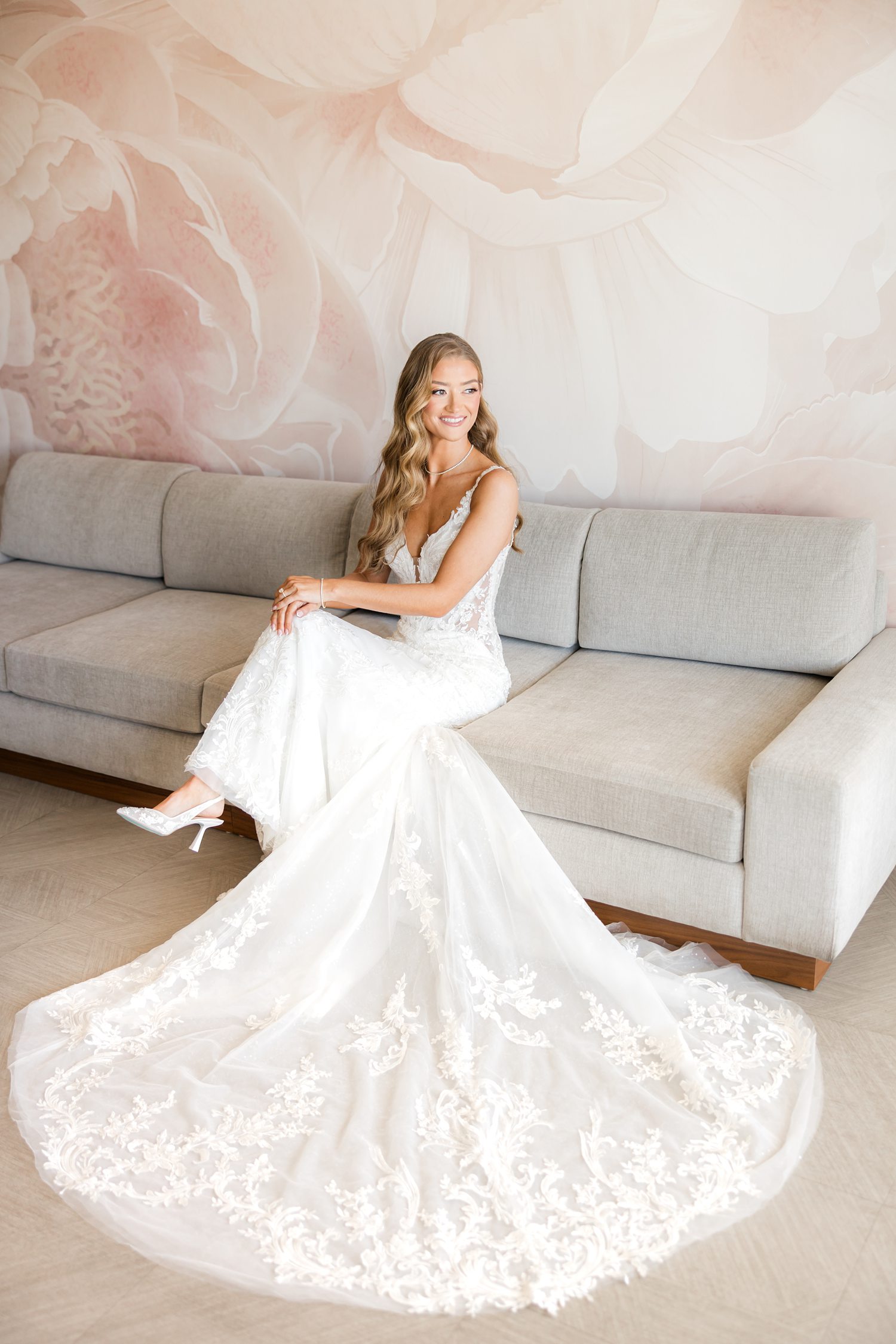 Bride sitting gracefully in wedding gown during bridal portrait session