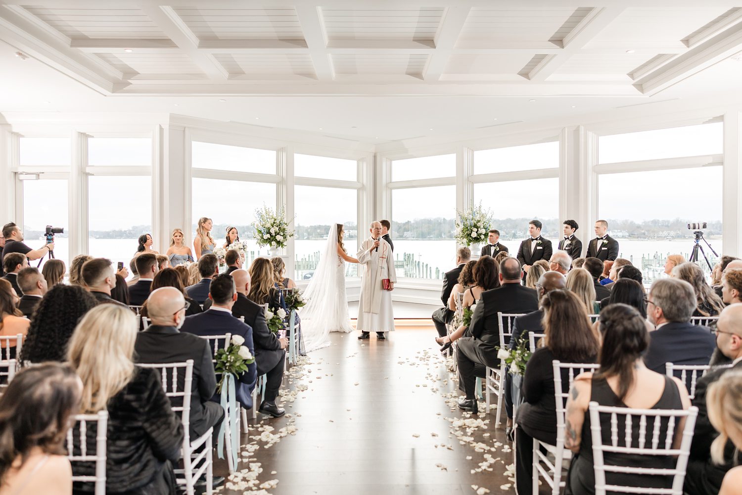 Guests seated during luxury yacht club wedding reception with waterfront views