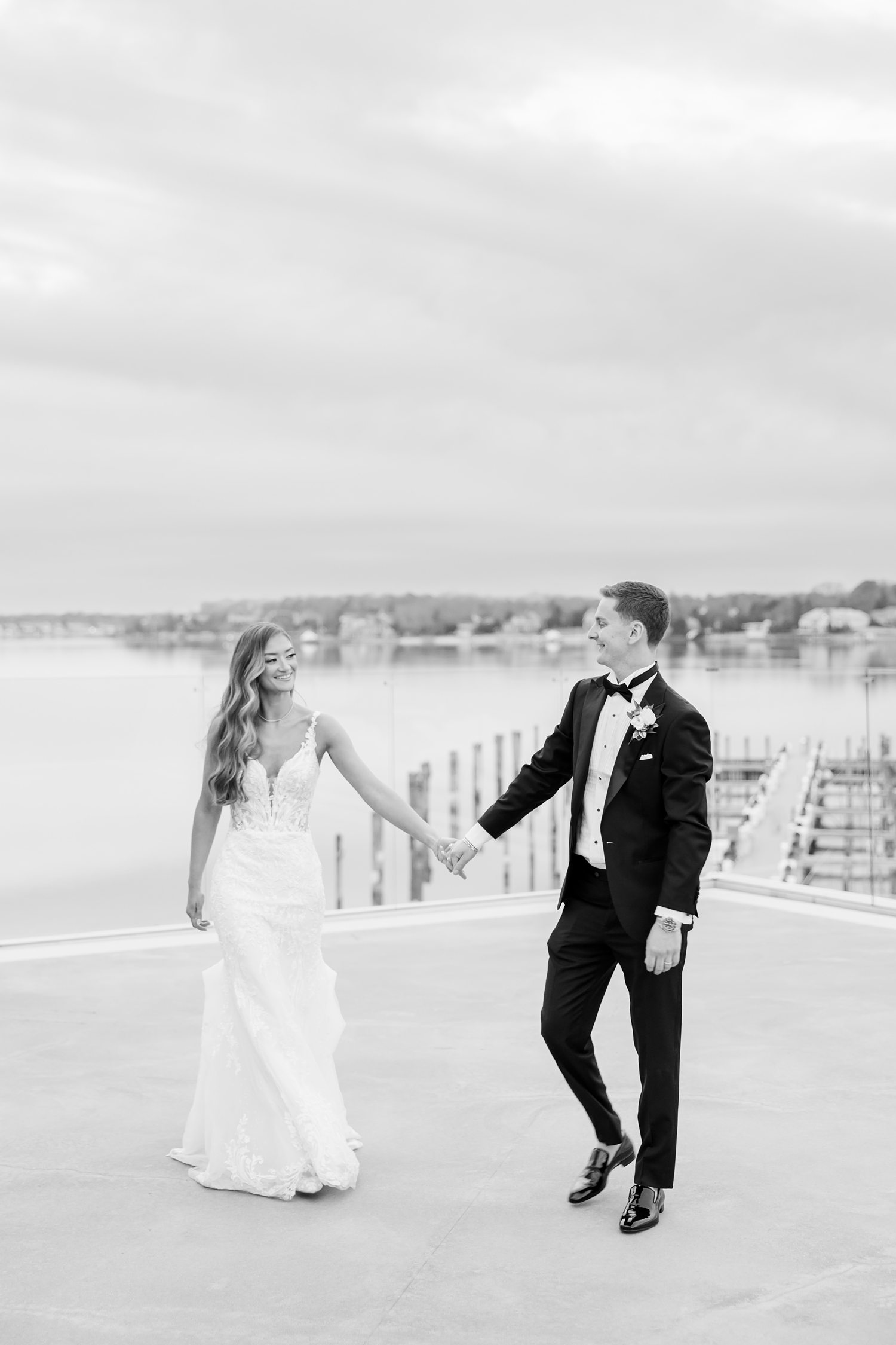 Black and white waterfront wedding portrait of bride and groom
