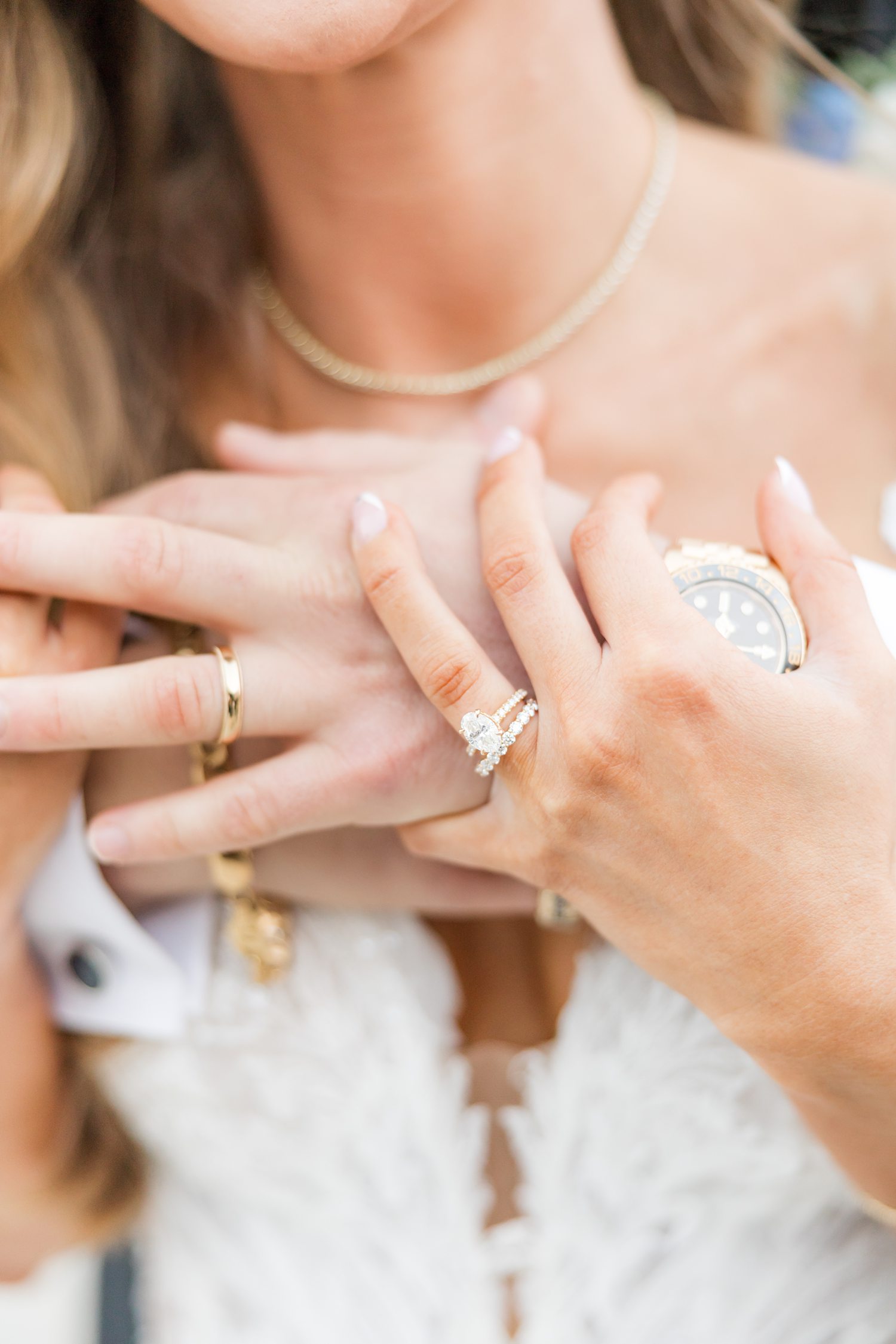 Close-up of bride showing elegant wedding rings and bridal manicure