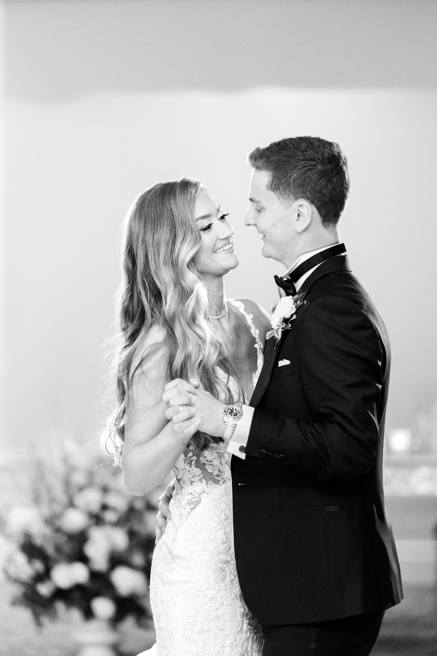 Black and white portrait of newlywed couple sharing intimate dance moment