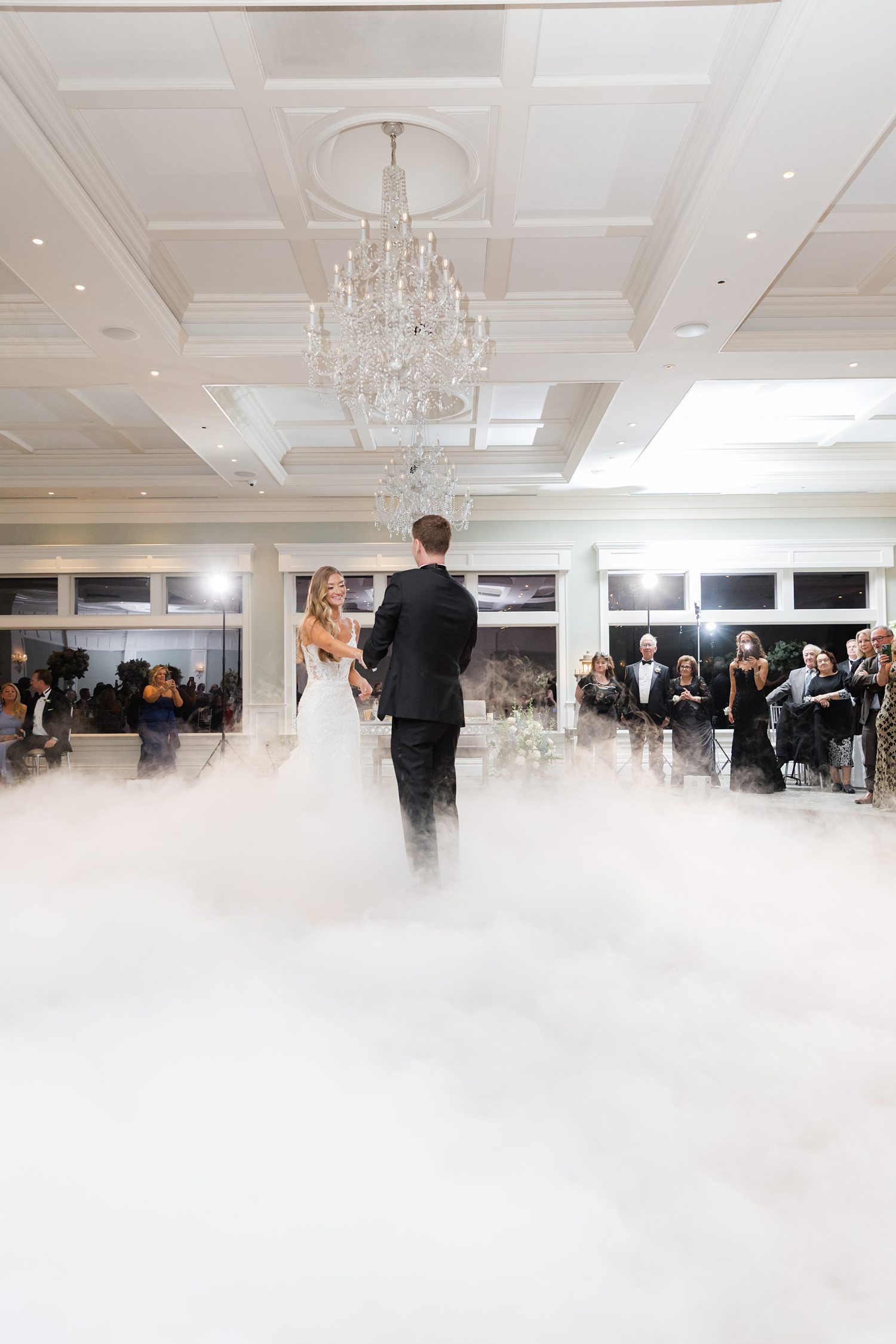 Wide view of elegant wedding reception ballroom with guests and dance floor