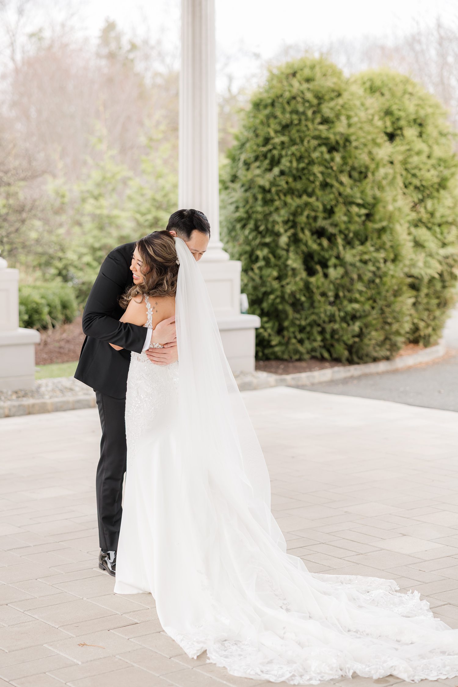 Romantic bride and groom portrait beneath archway at luxury wedding venue