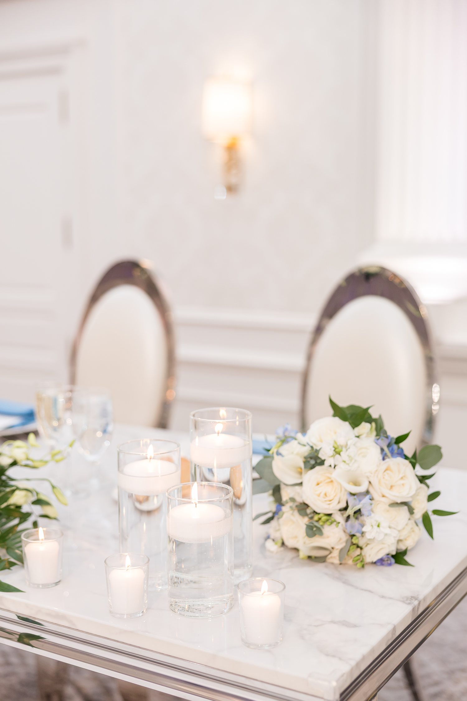 Minimalist wedding table decor with candles and floral centerpiece
